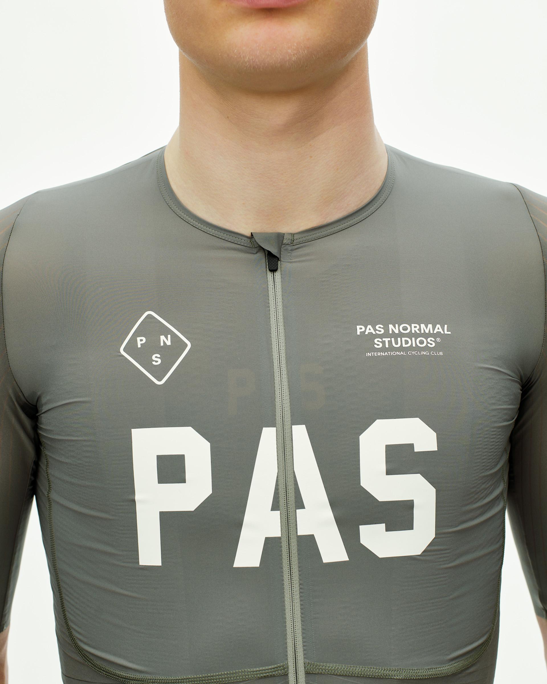 Grey PAS Mechanism Pro cycling jersey on model with white chest logo and full zip