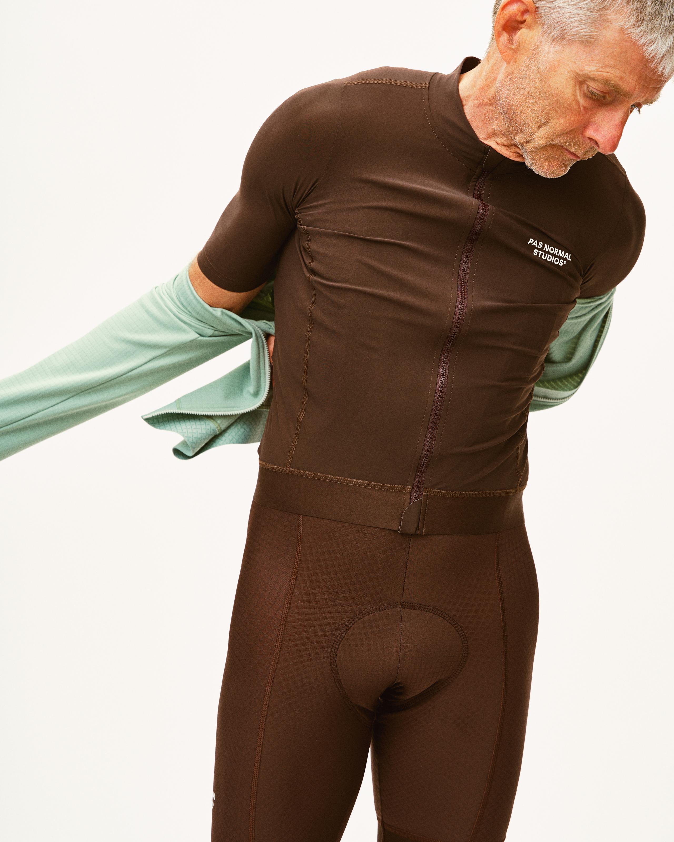 Light Brown Essential cycling bibs on model with full zip front and chamois pad