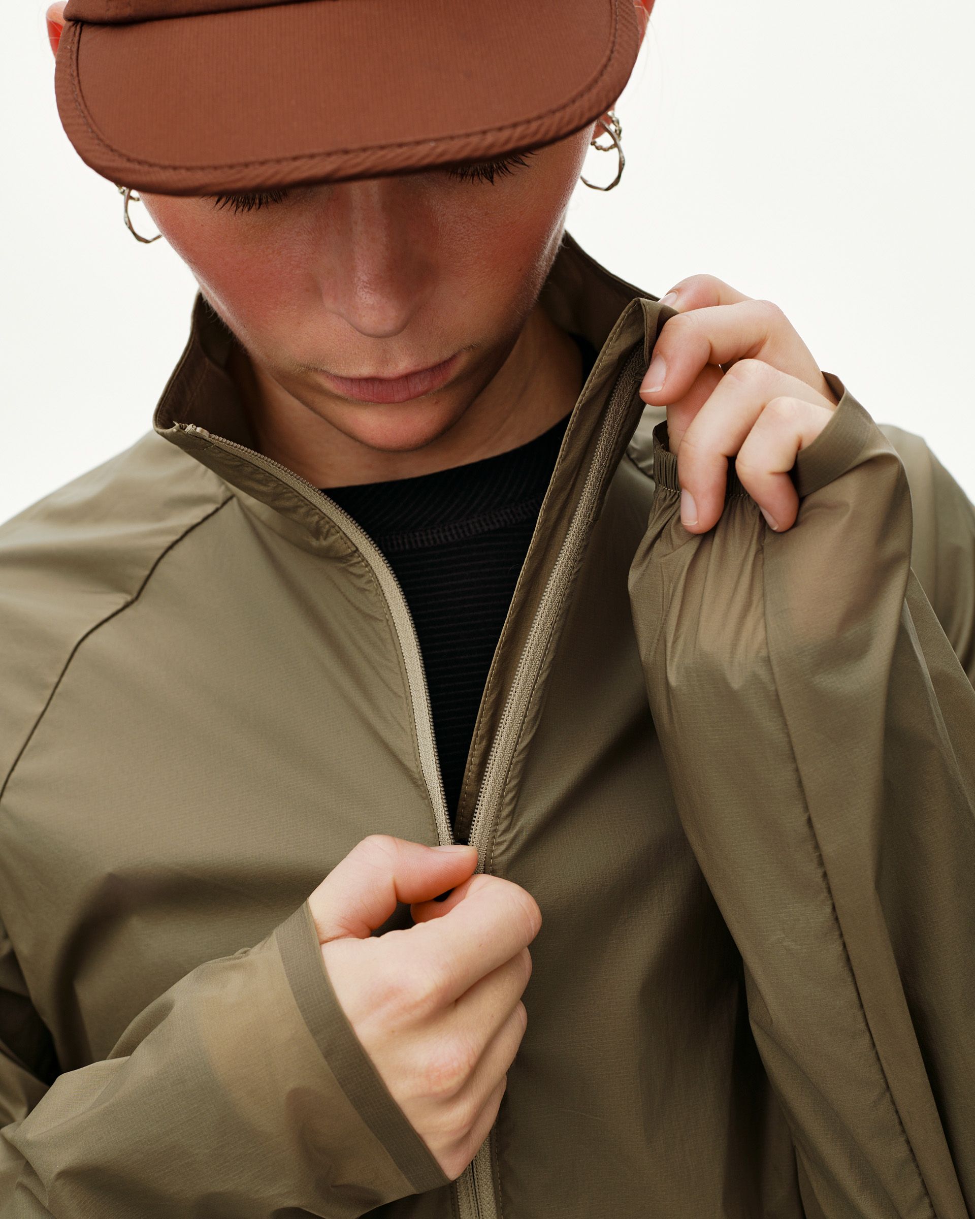 Dusty Earth khaki Balance Windproof jacket, front detail on model with zip open at collar