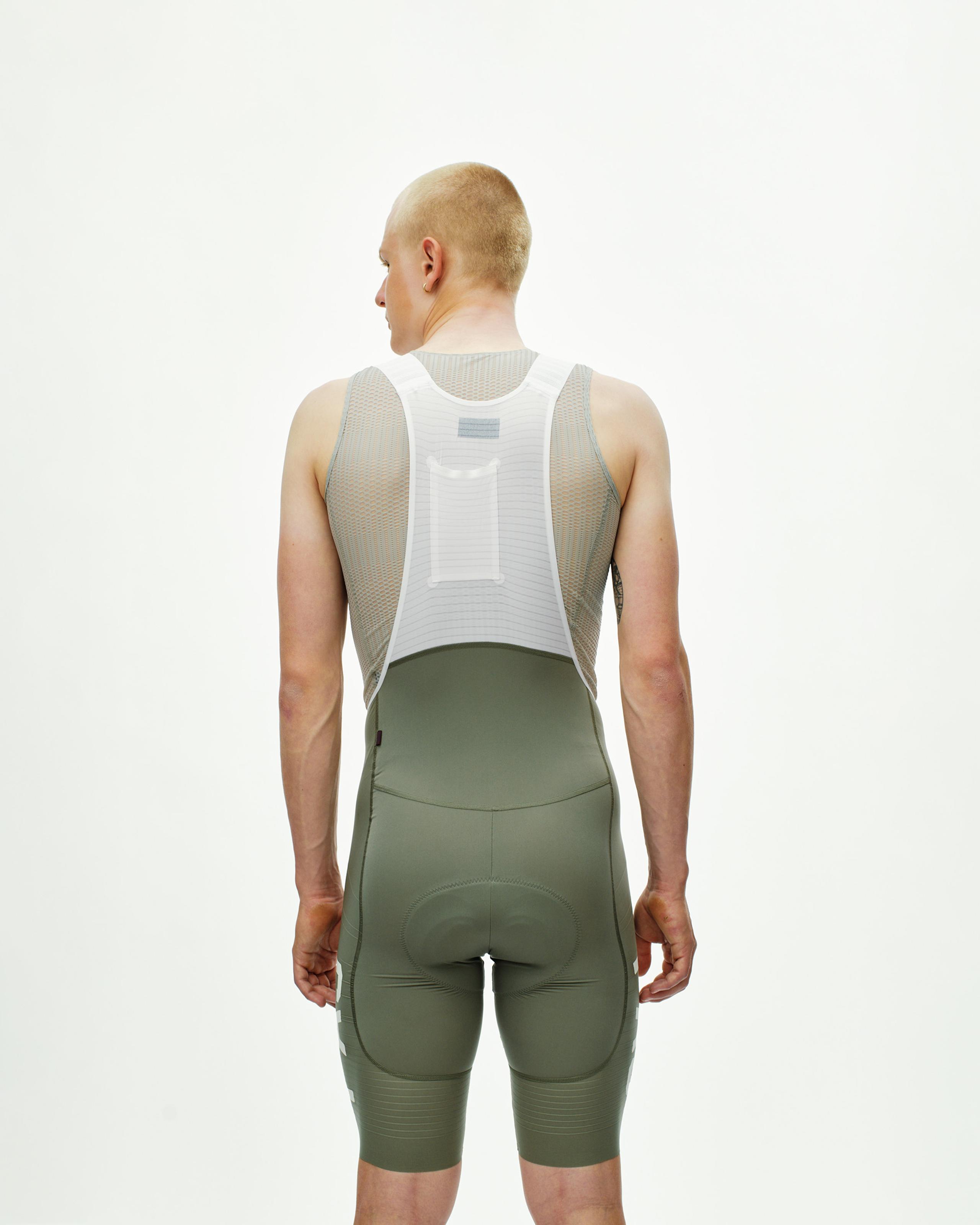 Grey Moss PAS Mechanism Pro cycling bibs on model, rear view with white mesh base layer