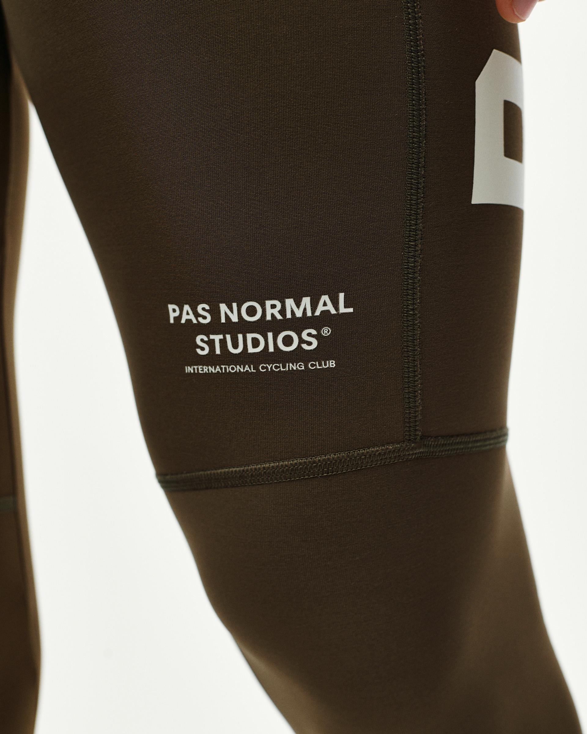 Dark Earth brown PAS Mechanism Thermal Long cycling bibs, thigh detail on model with white logo print