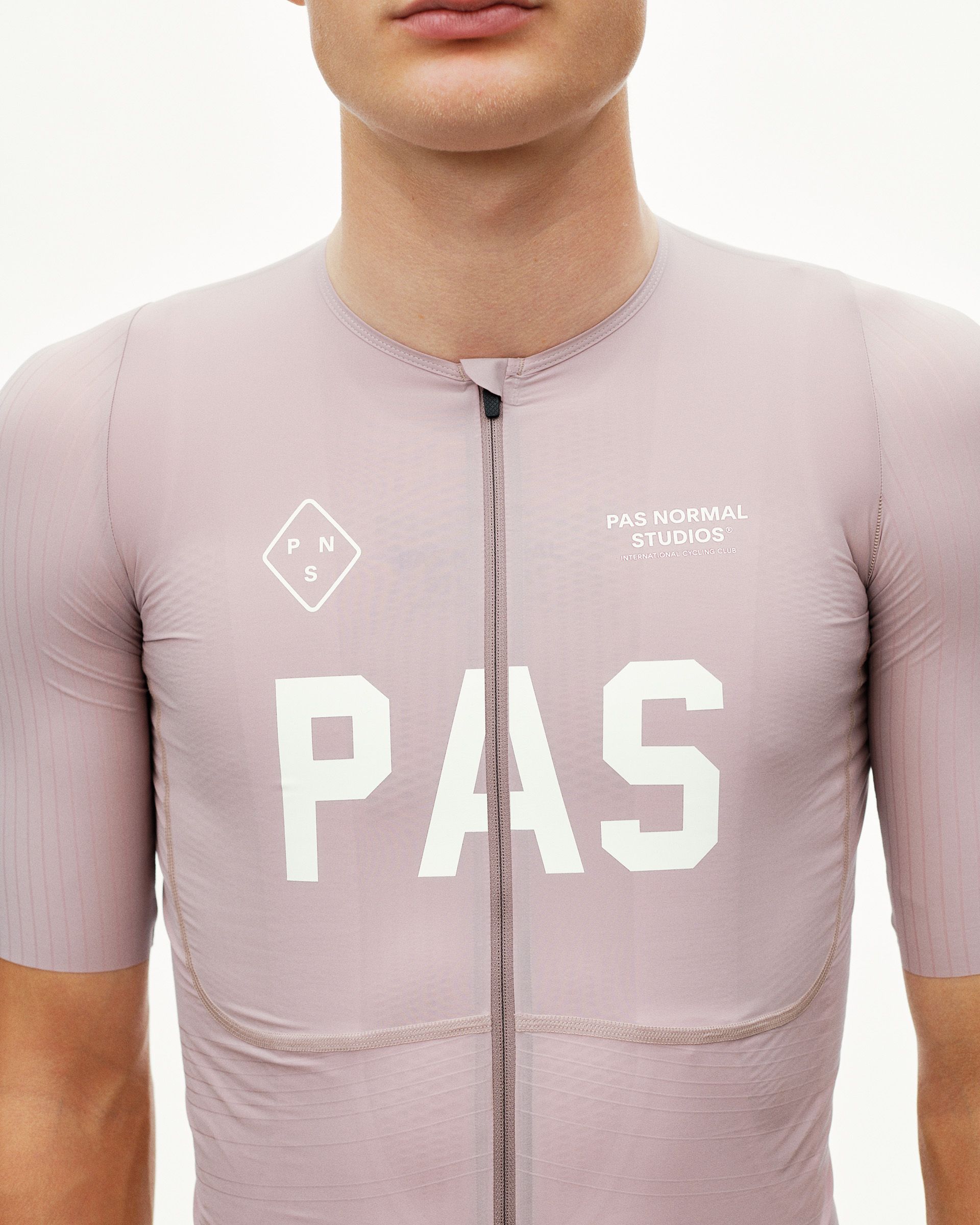 Taupe Rose PAS Mechanism Pro cycling jersey on model, front view with large white chest print and full-length zip