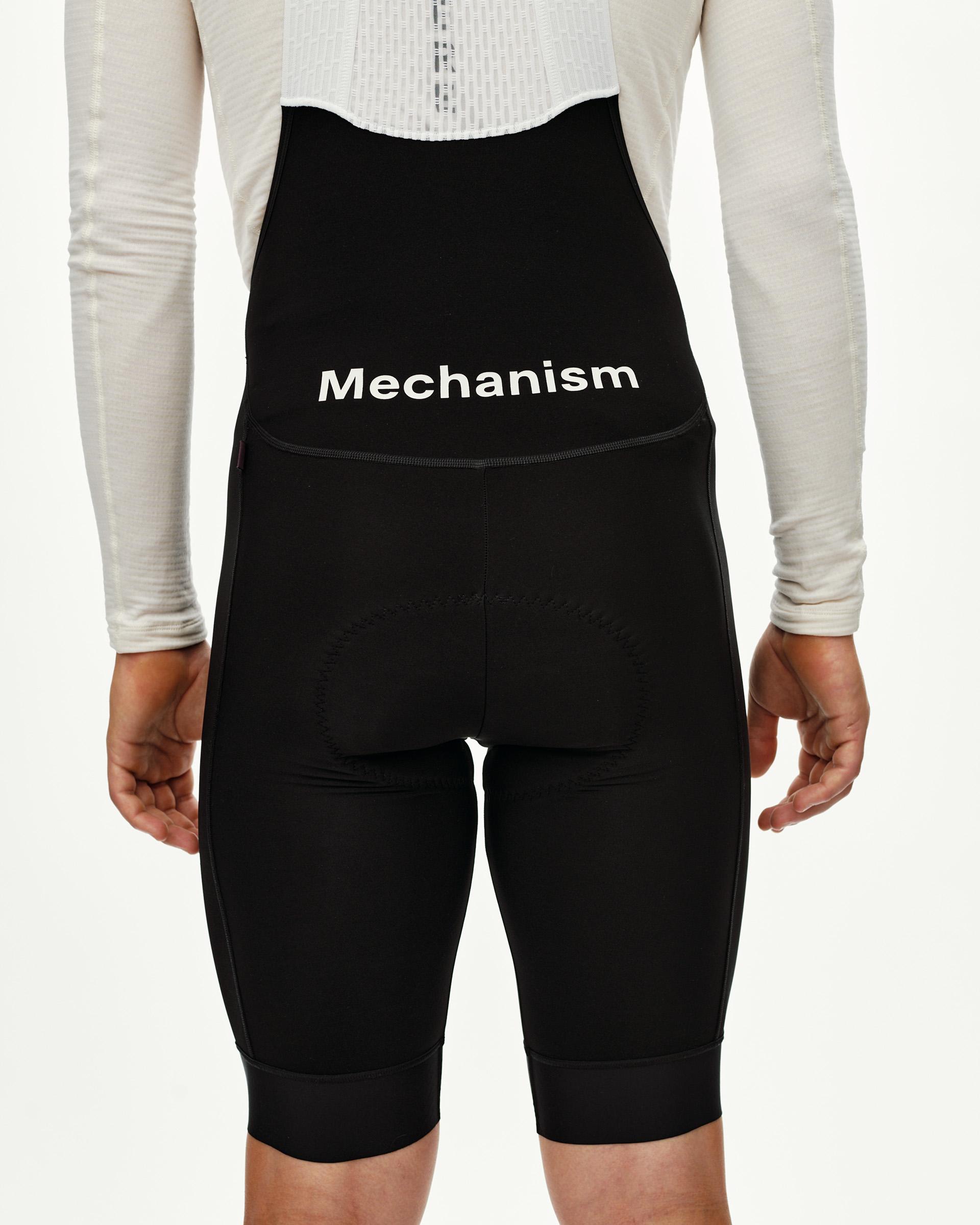 Black Mechanism Thermal cycling bibs on model, rear view with white waistband logo