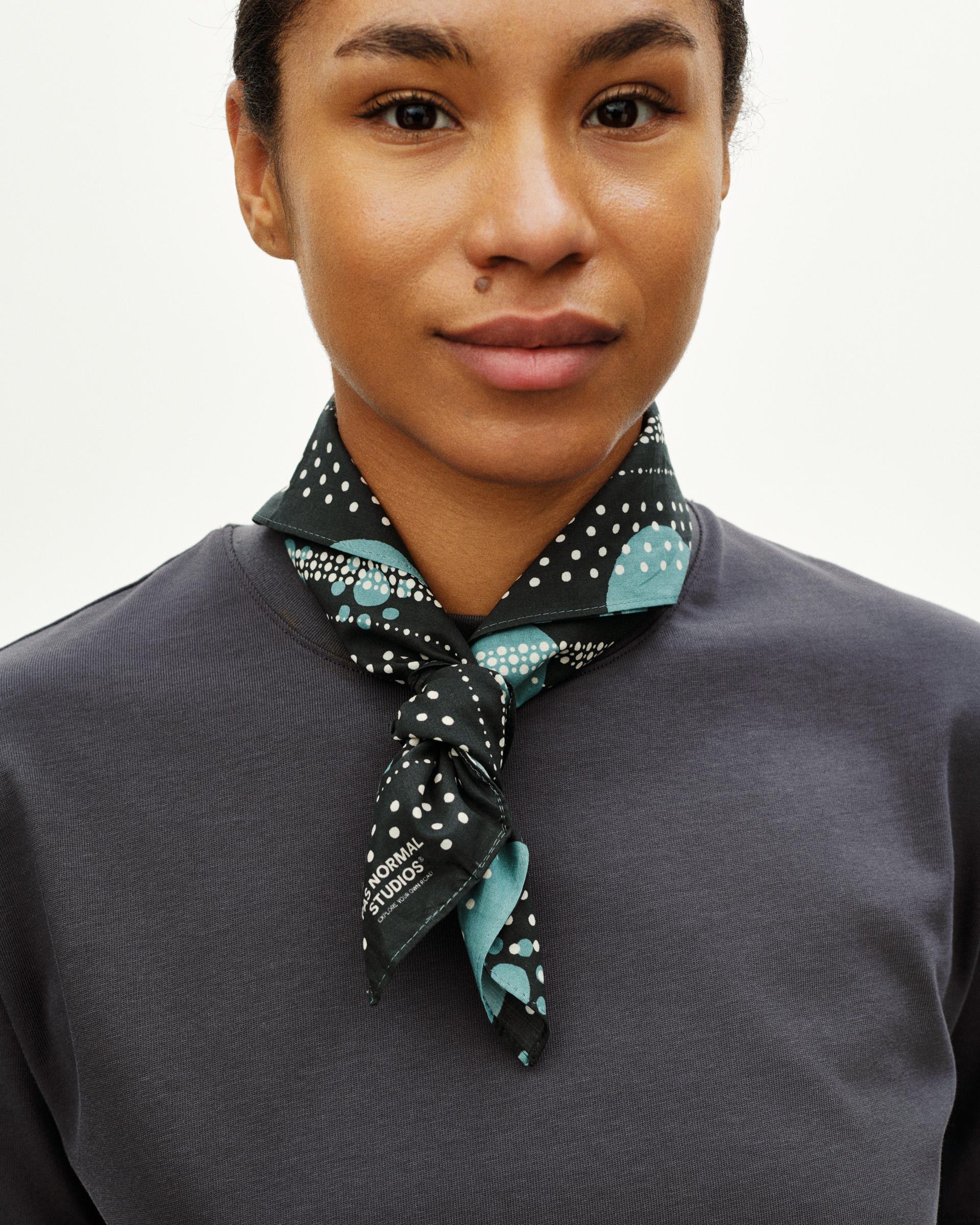 Navy Essential Off-Race bandana on model, tied at neck with white polka dot and mint green pattern