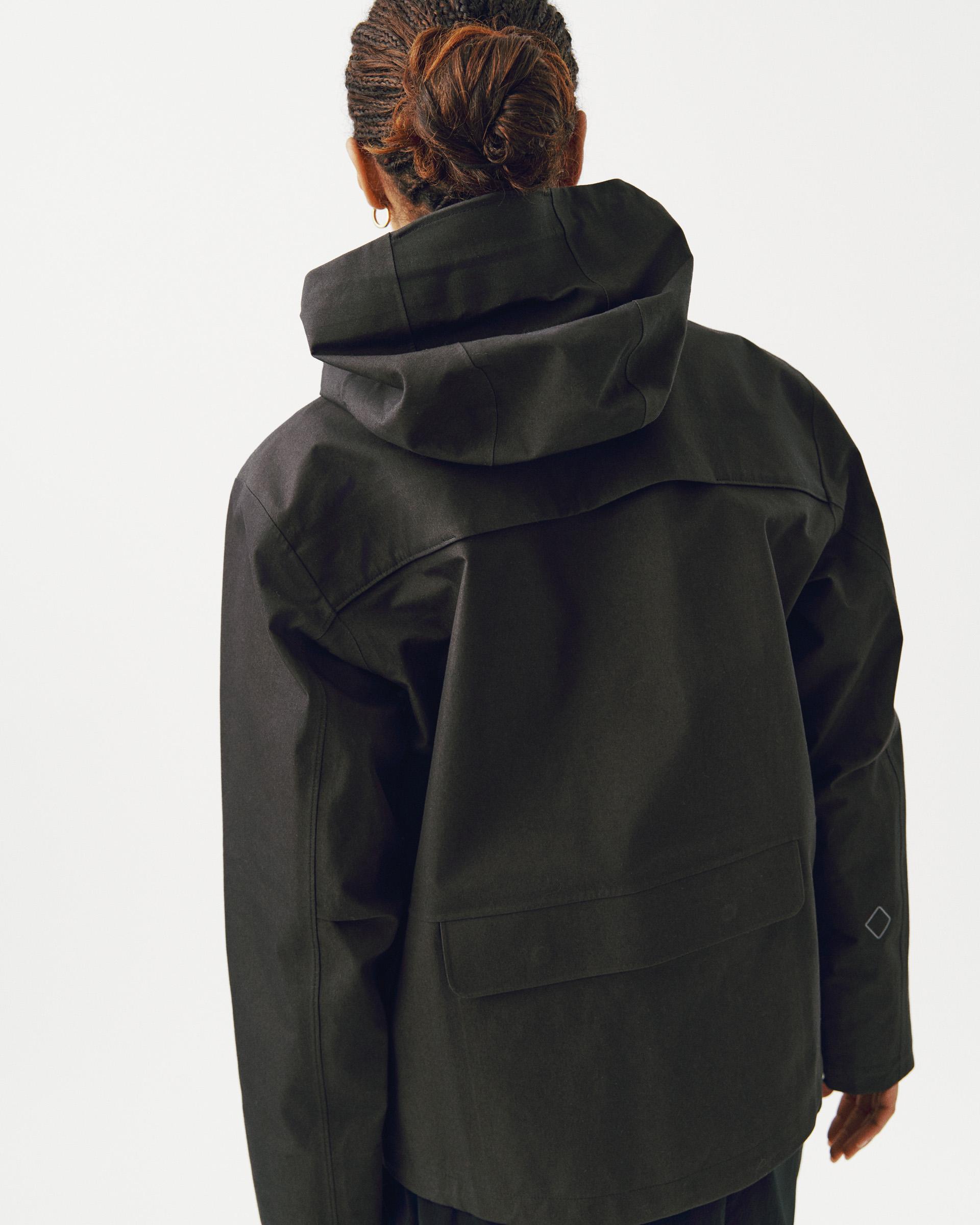 Dark Olive Off-Race 3L Cotton Shell jacket, rear view on model with oversized hood and back seaming detail