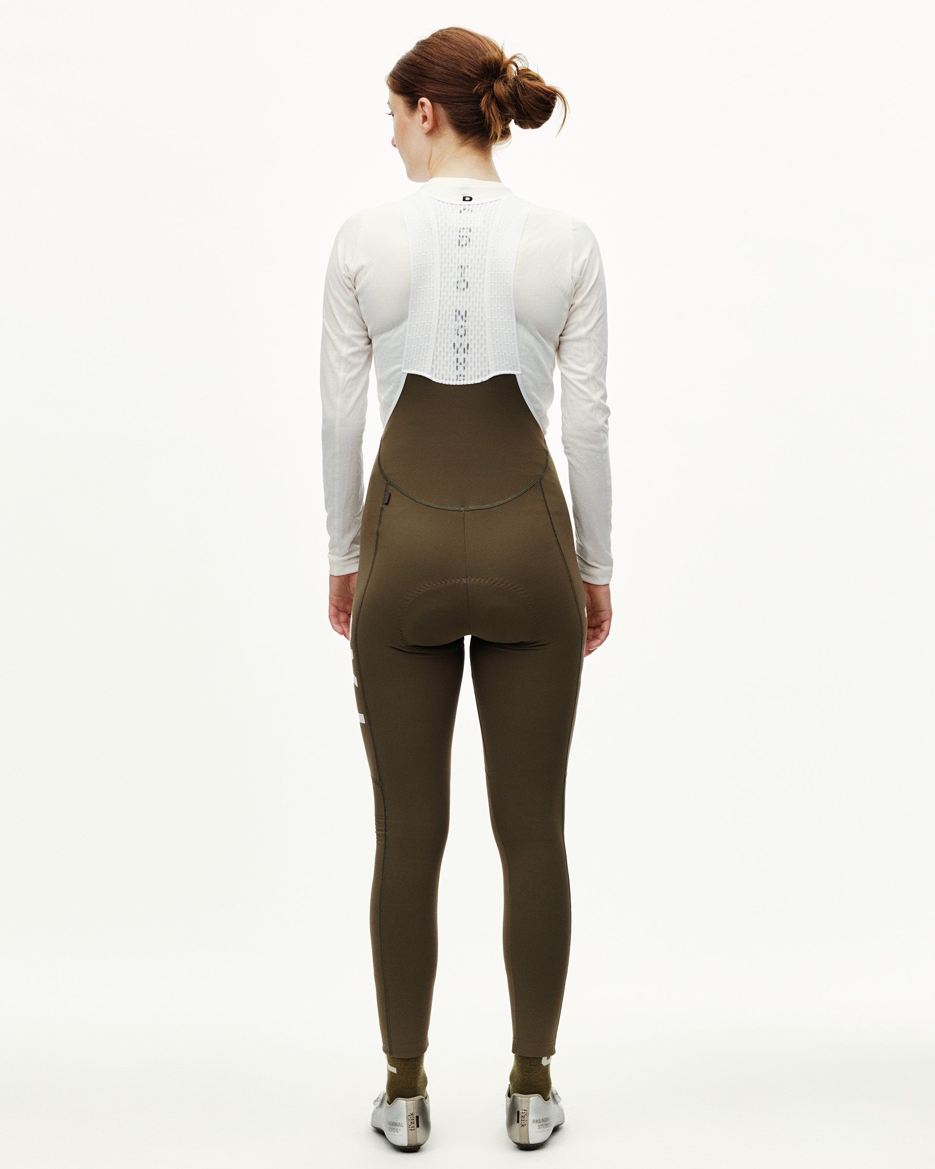 Dark Earth khaki PAS Mechanism women's thermal cycling long bibs on model, rear view