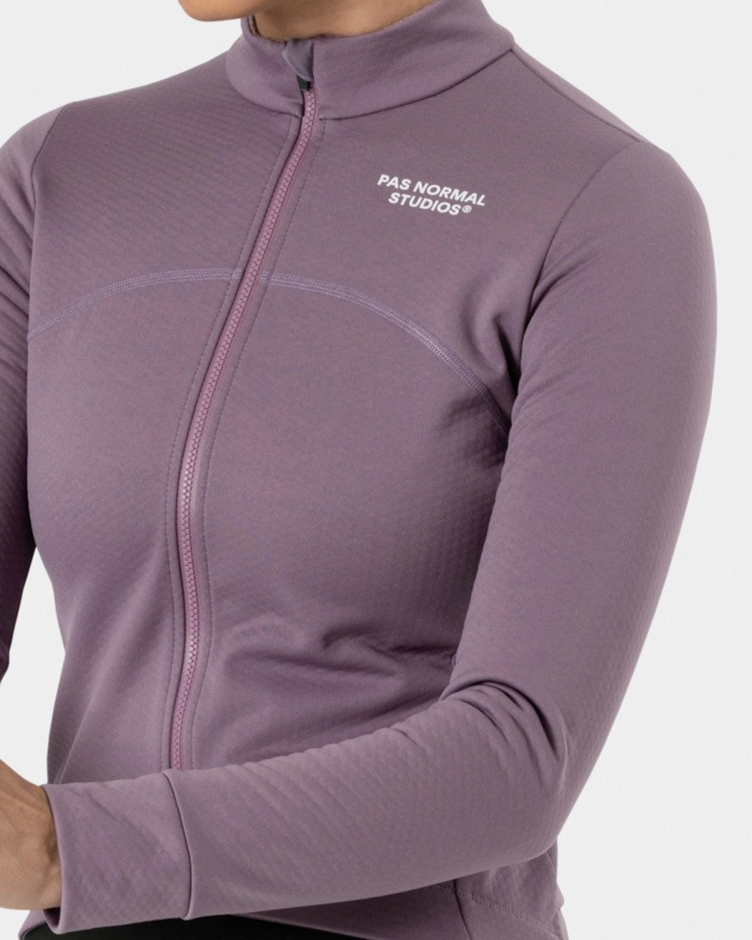 Purple Essential Thermal long sleeve cycling jersey on model with quarter zip and white chest logo