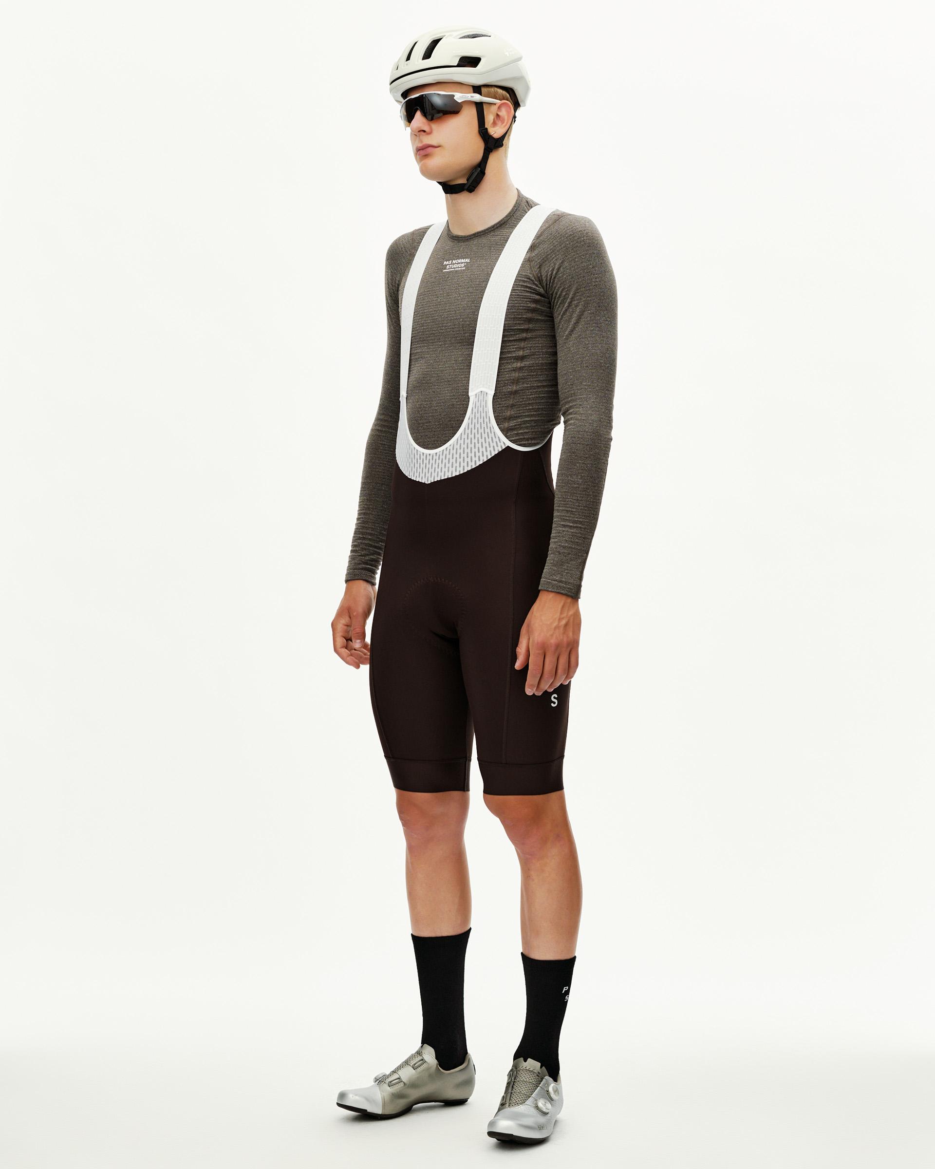 Dark Coffee brown Mechanism Thermal cycling bibs on model, three-quarter front view with white mesh bib straps