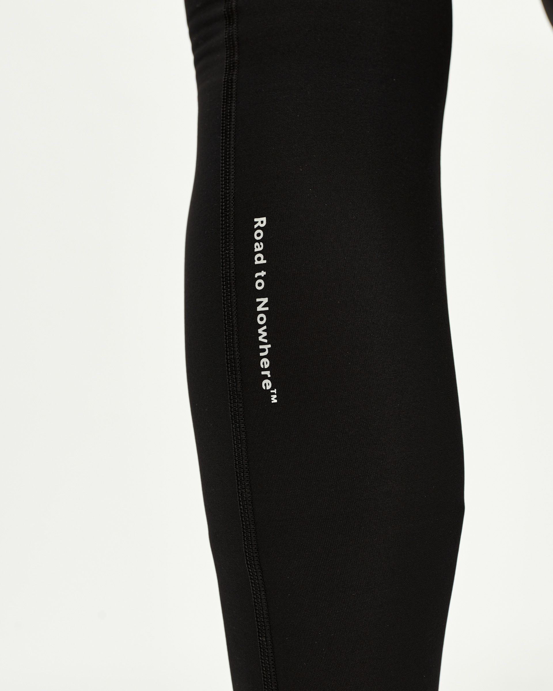 Black Mechanism Thermal Long cycling bibs, side detail on model with white Road to Nowhere leg print
