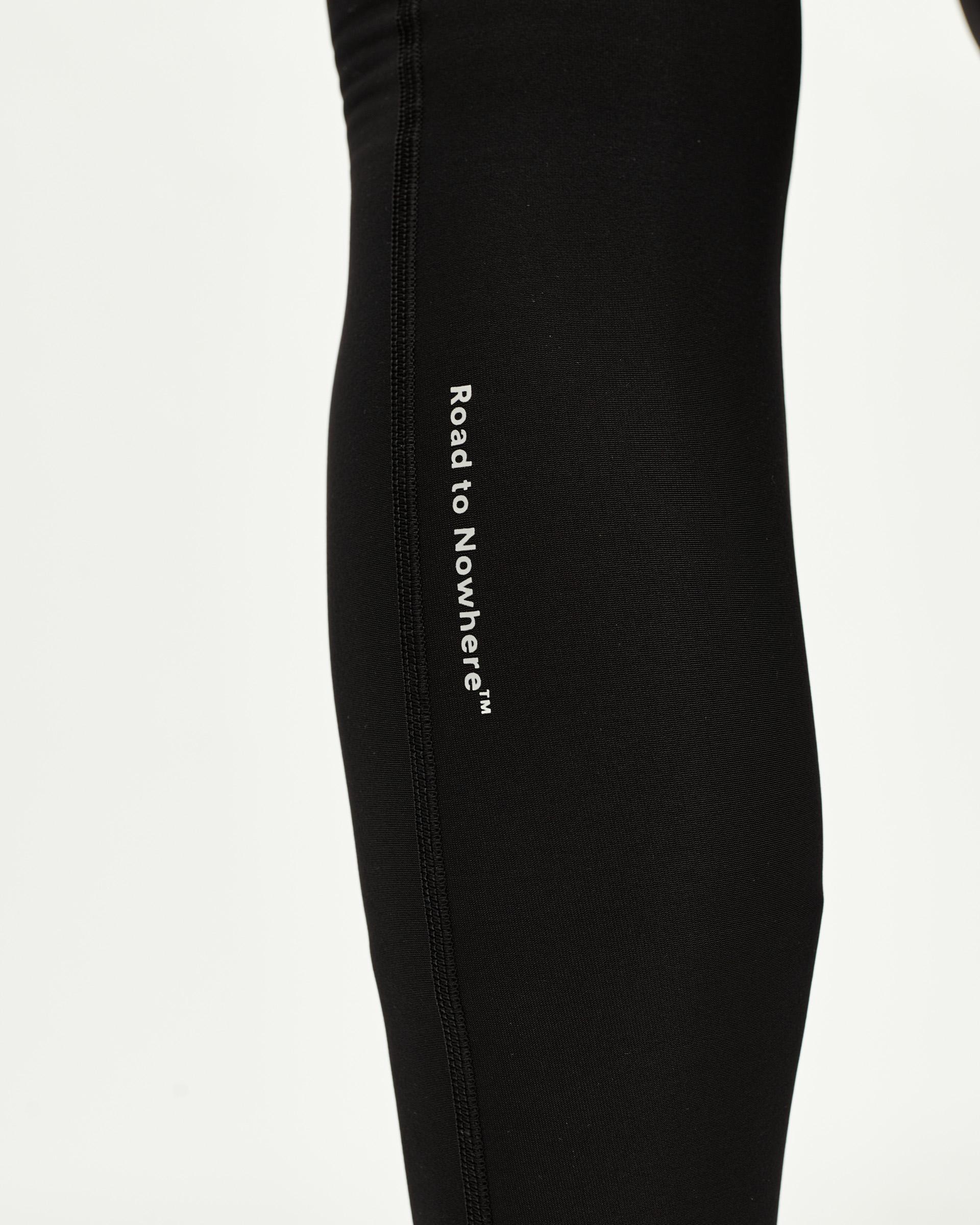 Black Mechanism Thermal Long cycling bibs, side detail on model with white Road to Nowhere leg print