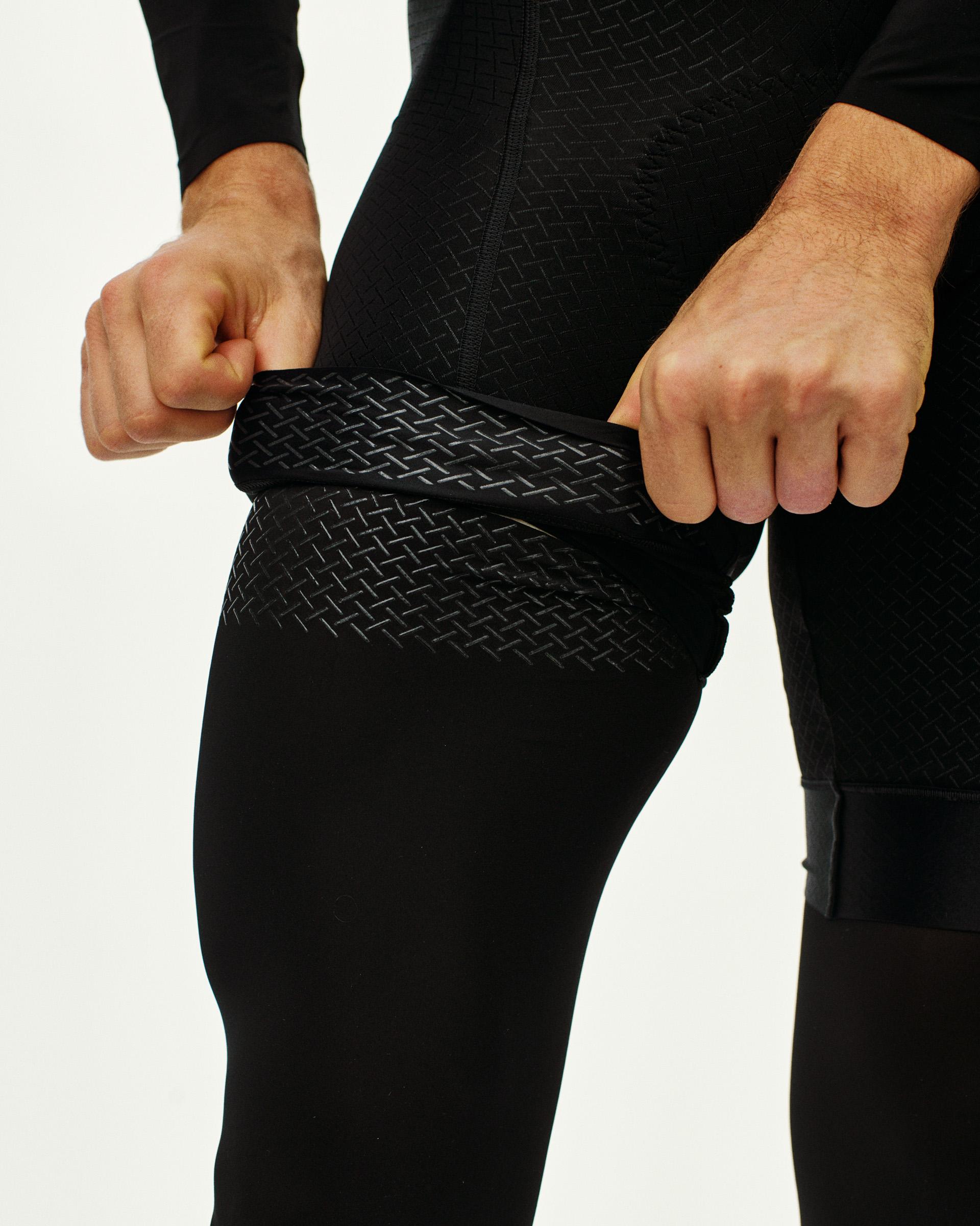Black Logo Leg UV Protector leg warmers on model showing geometric pattern detail