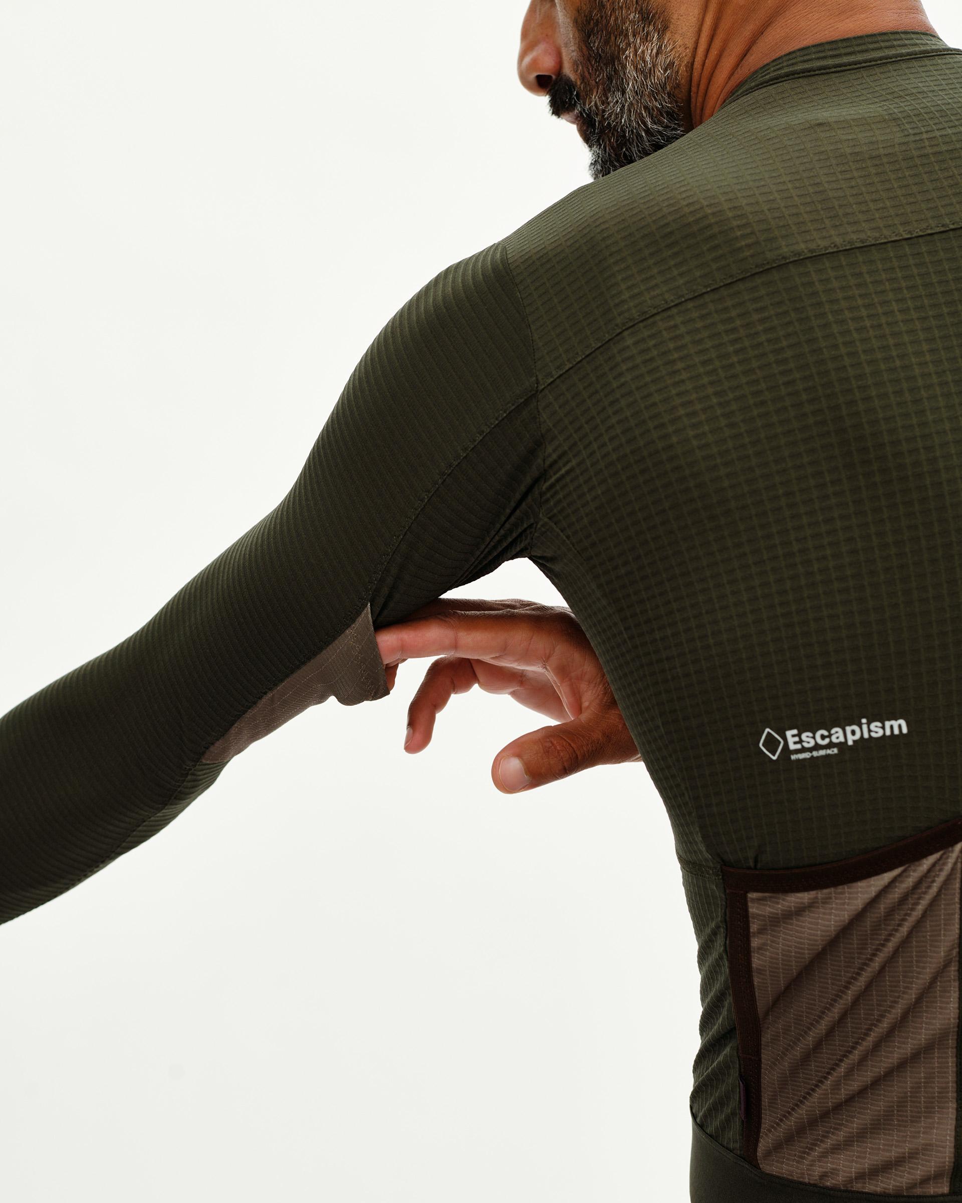 Dark Olive Escapism long sleeve cycling jersey on model, rear detail view with waffle texture and contrast pocket panel