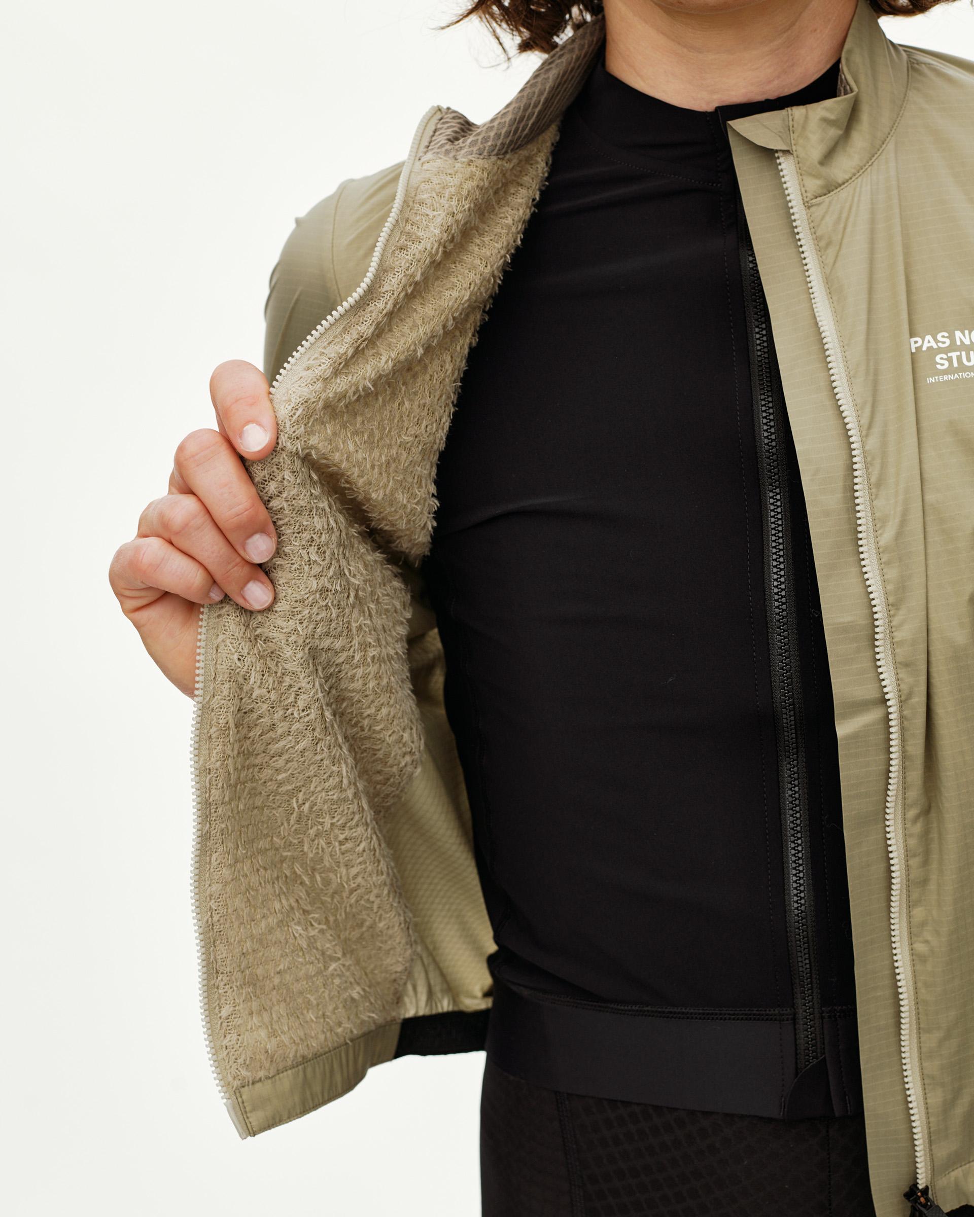 Grey Sage Essential Insulated jacket on model, detail view showing fleece inner lining