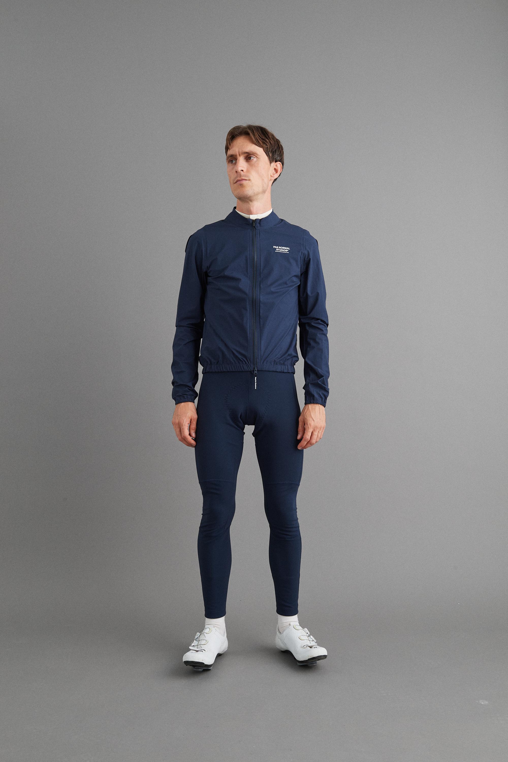 Navy Mechanism Pertex Rain cycling jacket on model with full zip and elastic hem