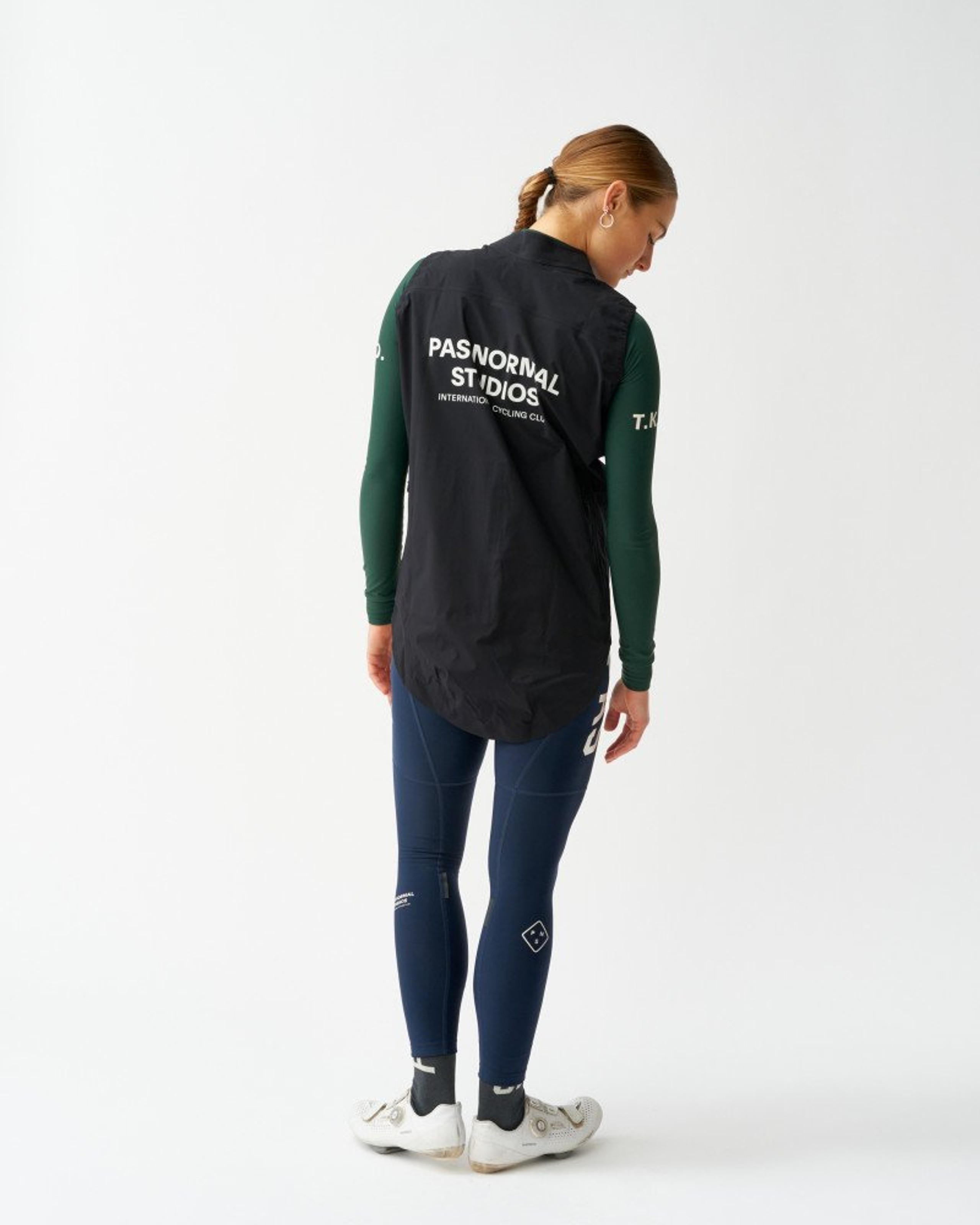 Black Essential Shield gilet on model, rear view with white back logo