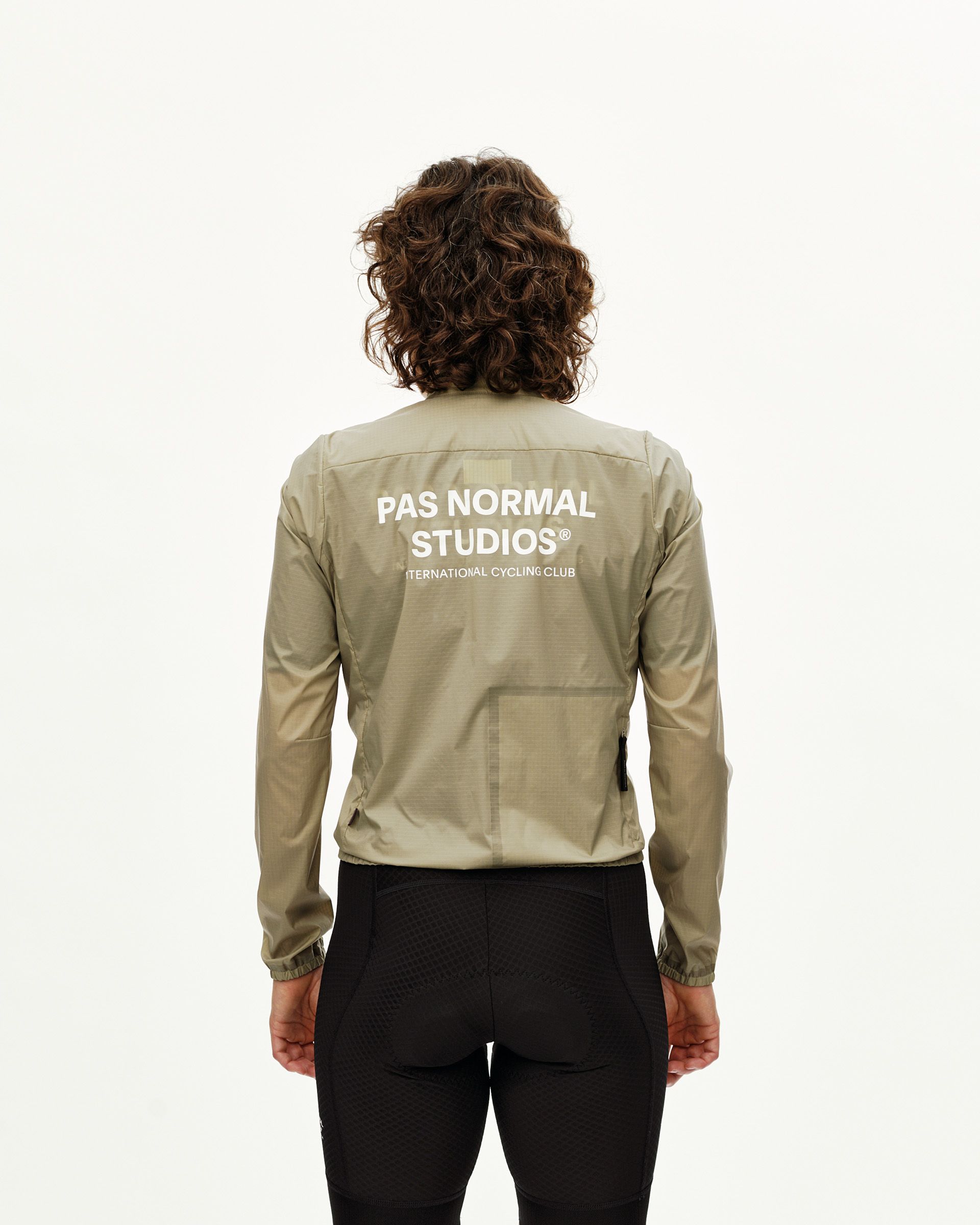 Grey Sage Essential Insulated cycling jacket on model, rear view with white back logo print