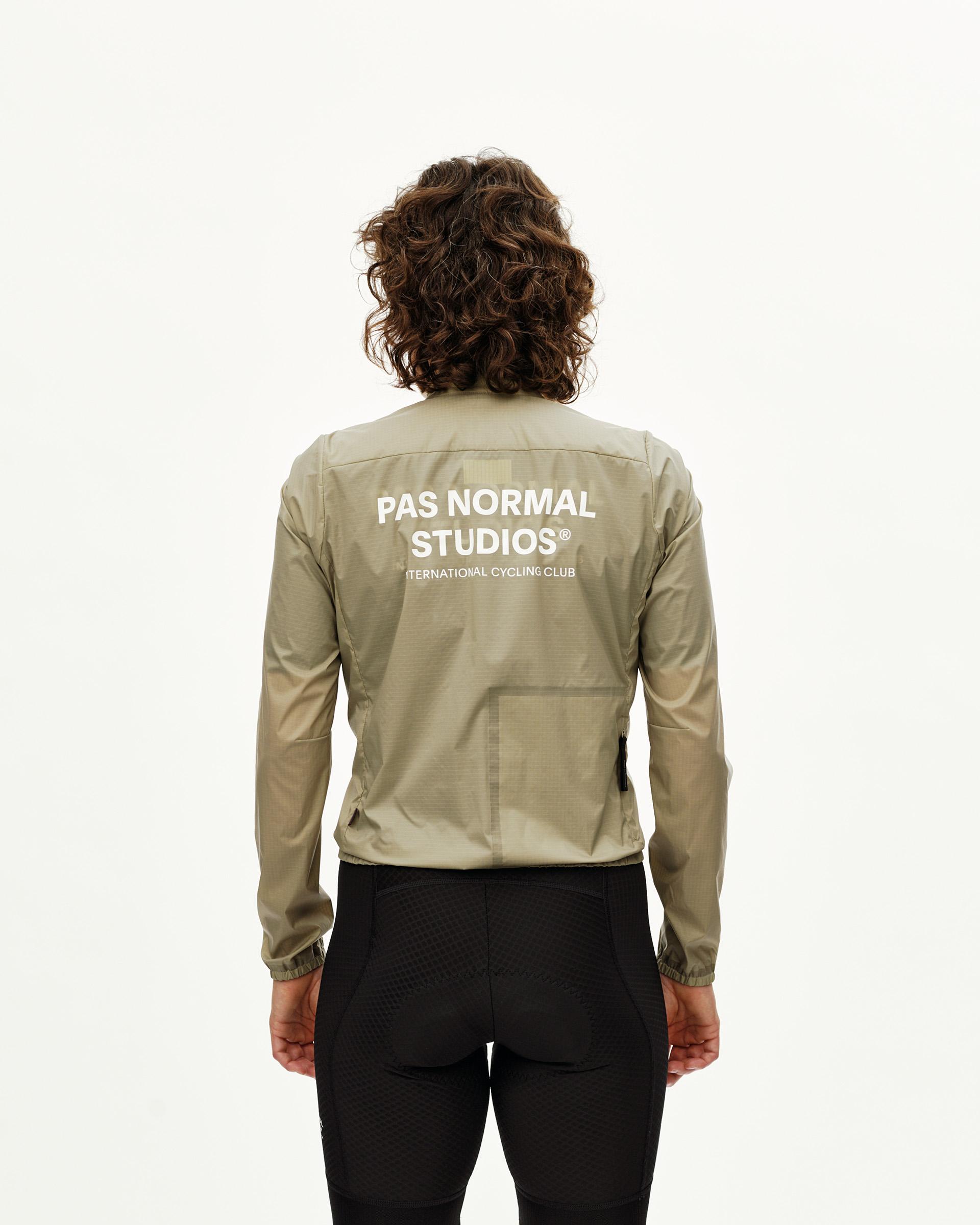 Grey Sage Essential Insulated cycling jacket on model, rear view with white back logo print