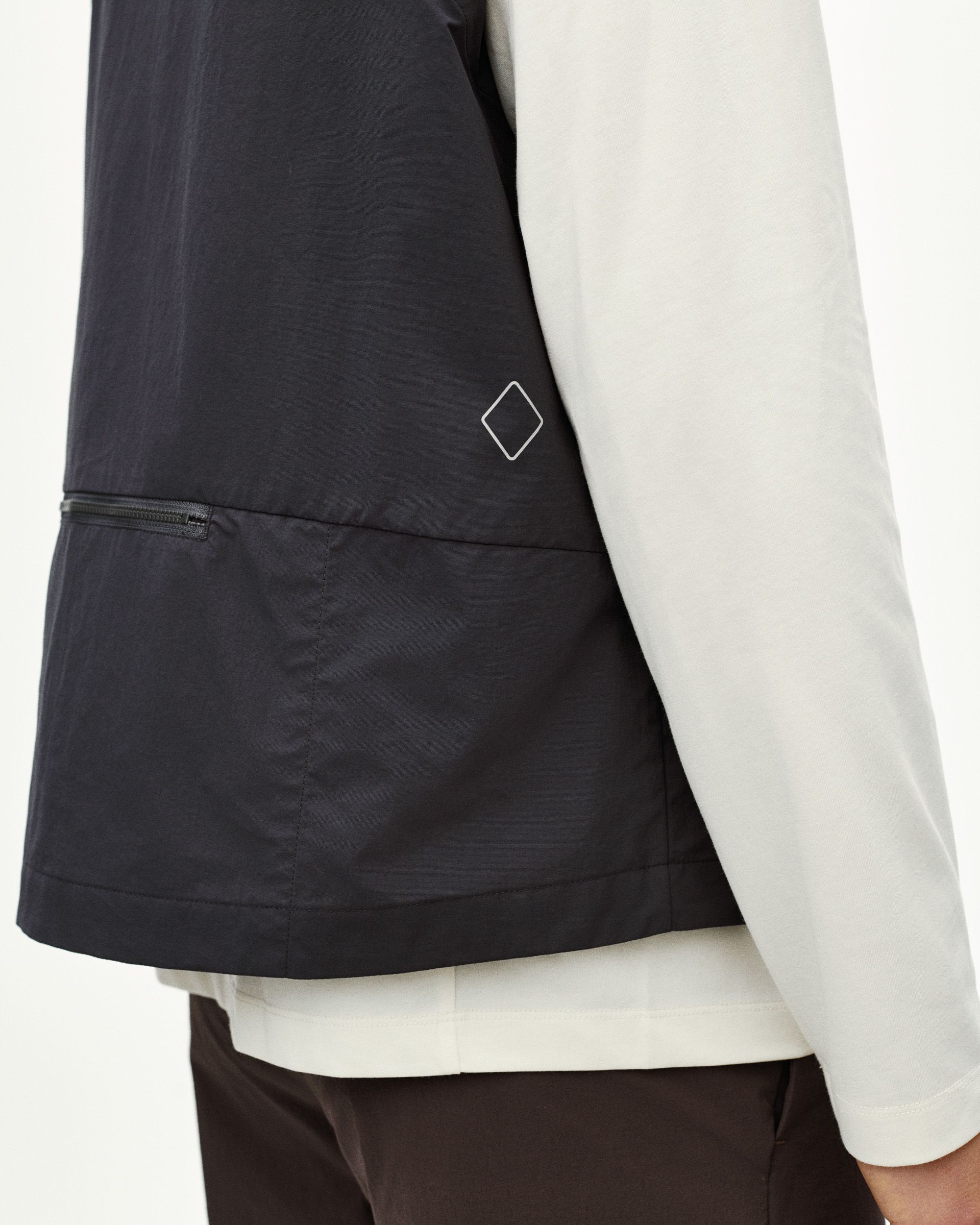 Grey Off-Race Utility vest on model with white diamond logo and zip pocket detail
