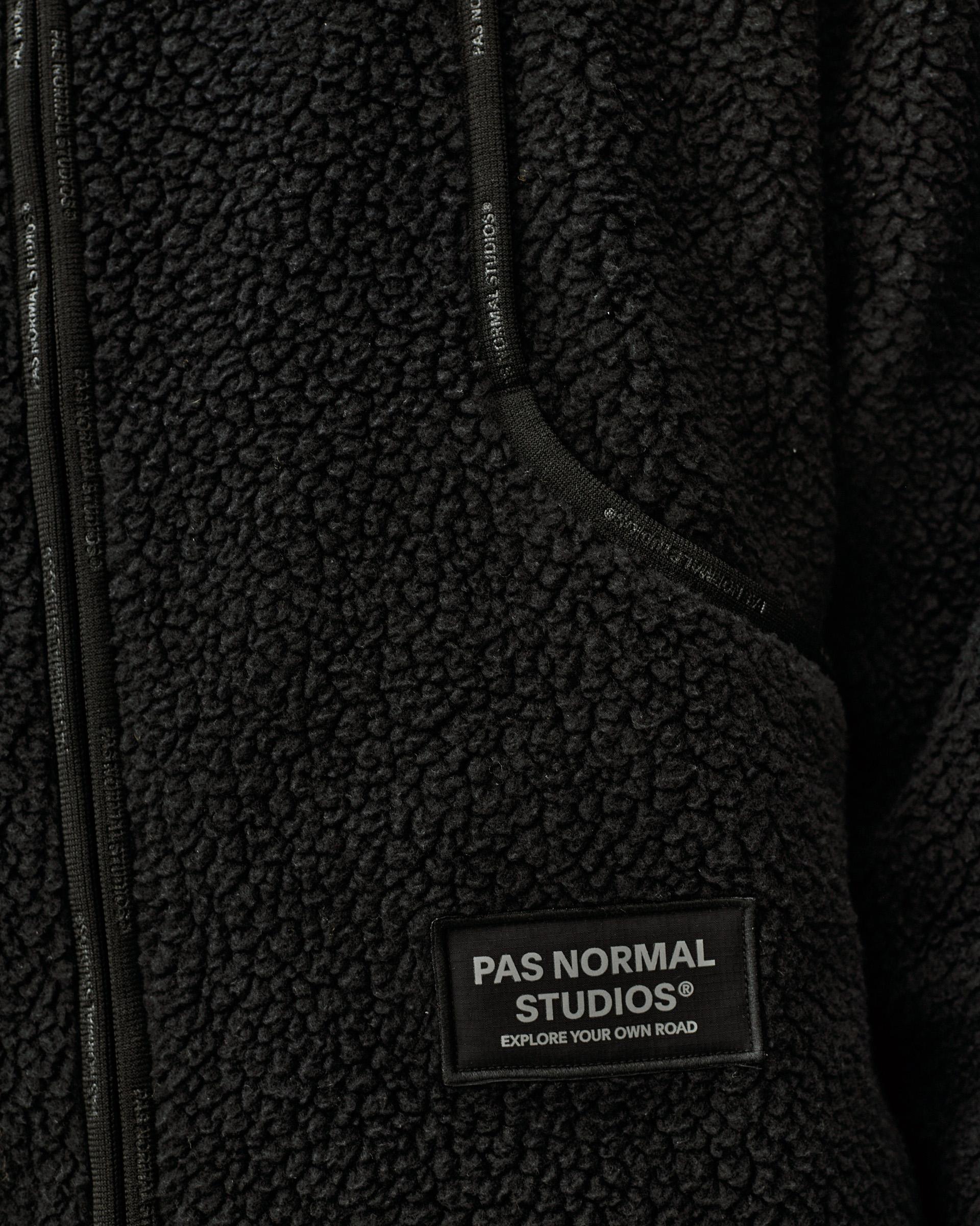 Black Off-Race Pile Fleece jacket, detail view of chest pocket and zip with woven brand label