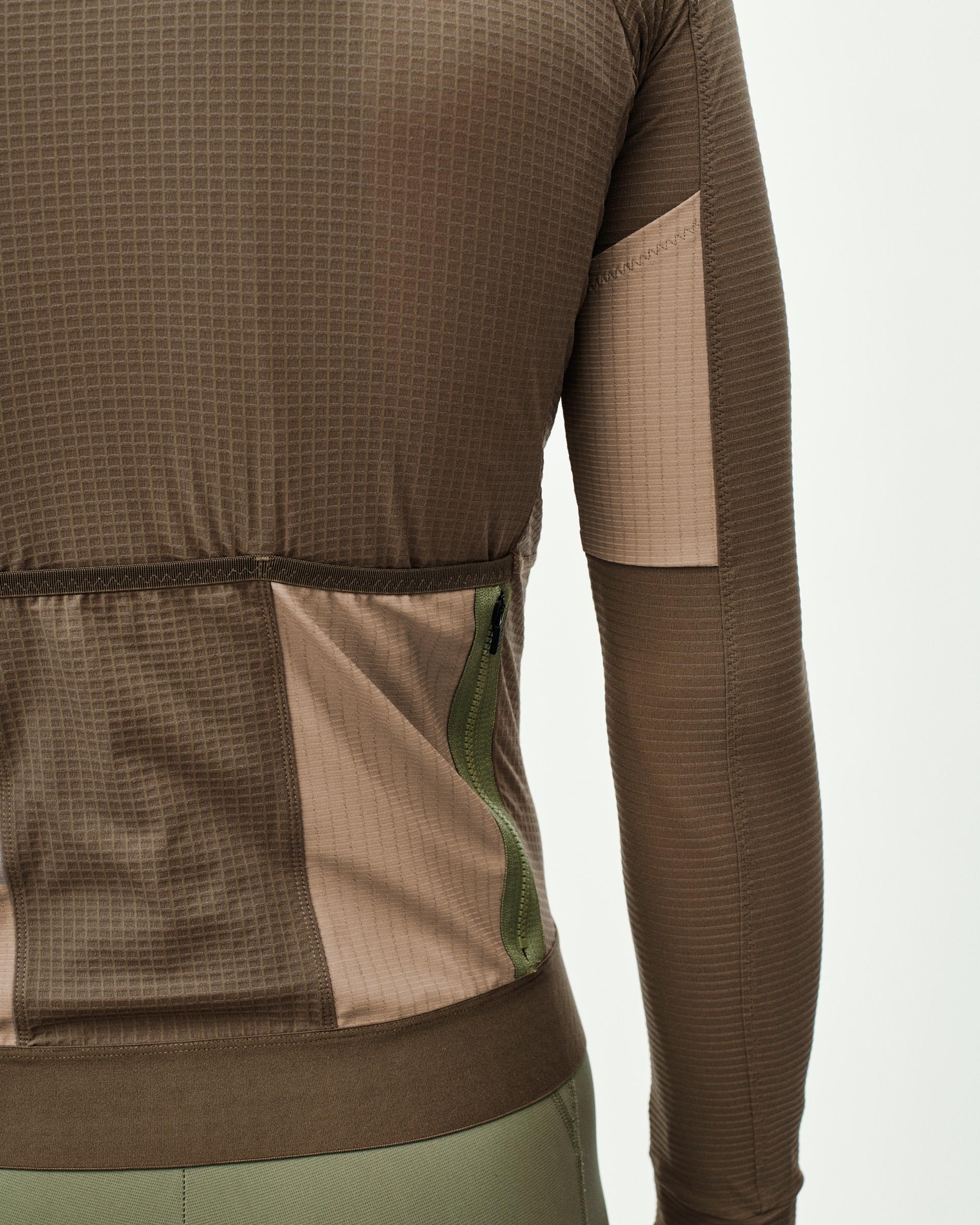 Brown Escapism long sleeve cycling jersey, side detail view with rear cargo pocket and green zipper