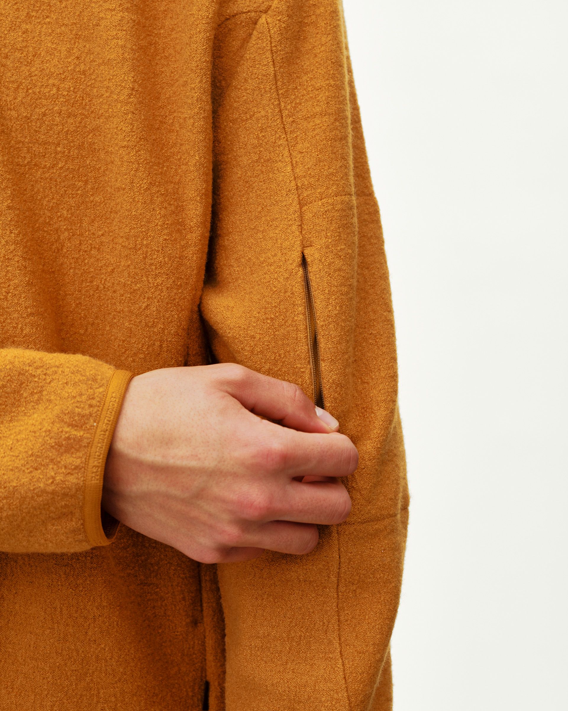 Ochre Off-Race Boiled Wool Half-Zip outerwear, side detail on model showing zip pocket
