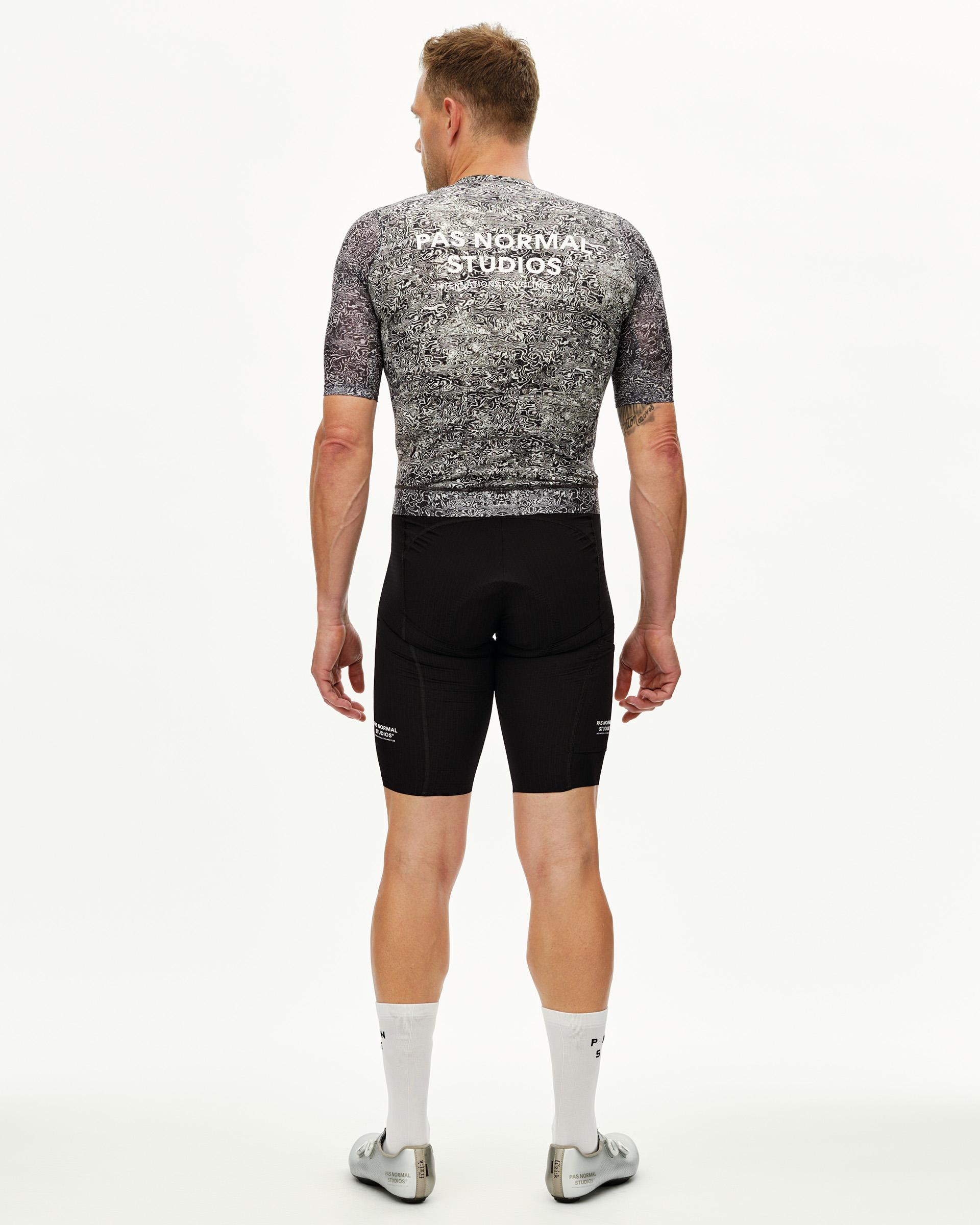 Off White Essential Light men's cycling jersey on model, rear view with all-over swirl print