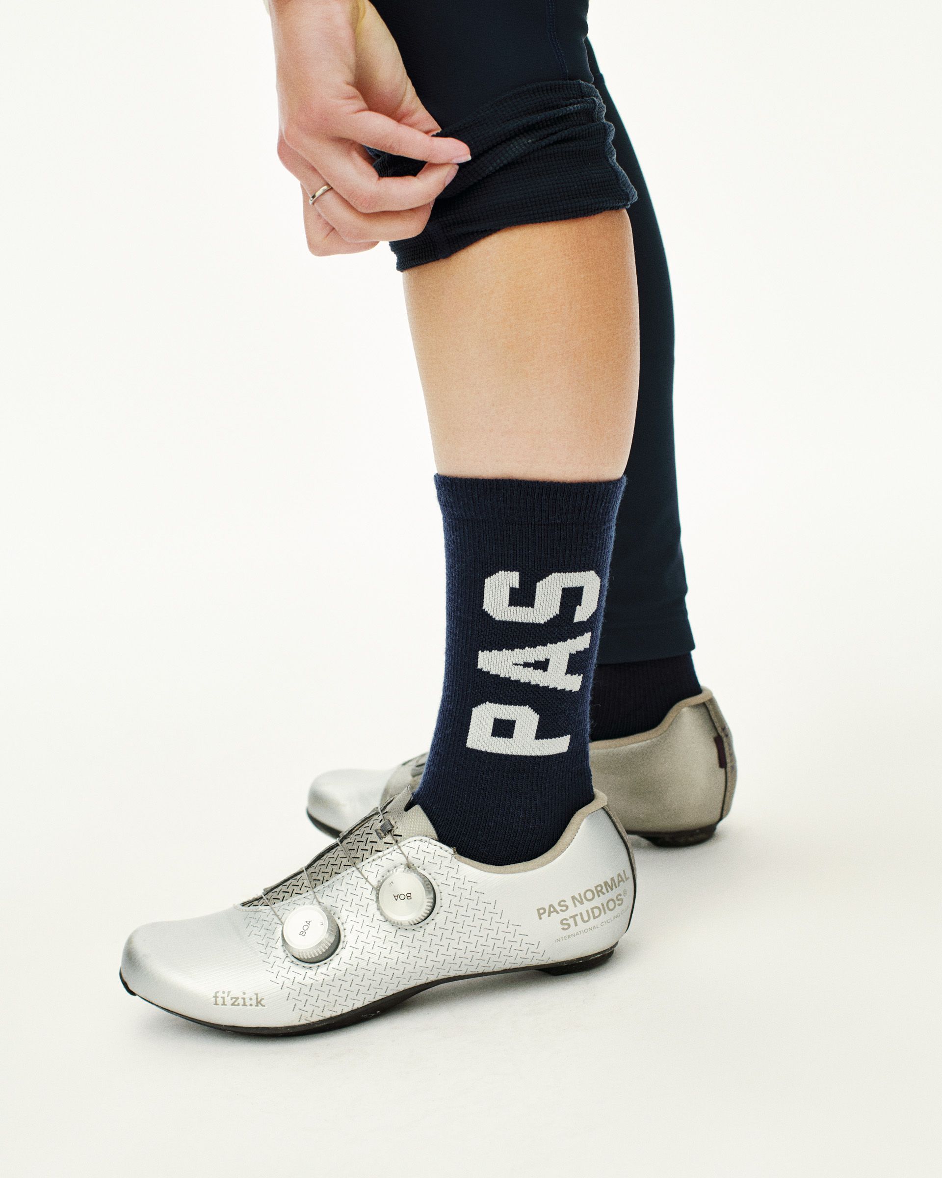 Navy PAS Thermal Wool cycling socks on model with white PAS text branding