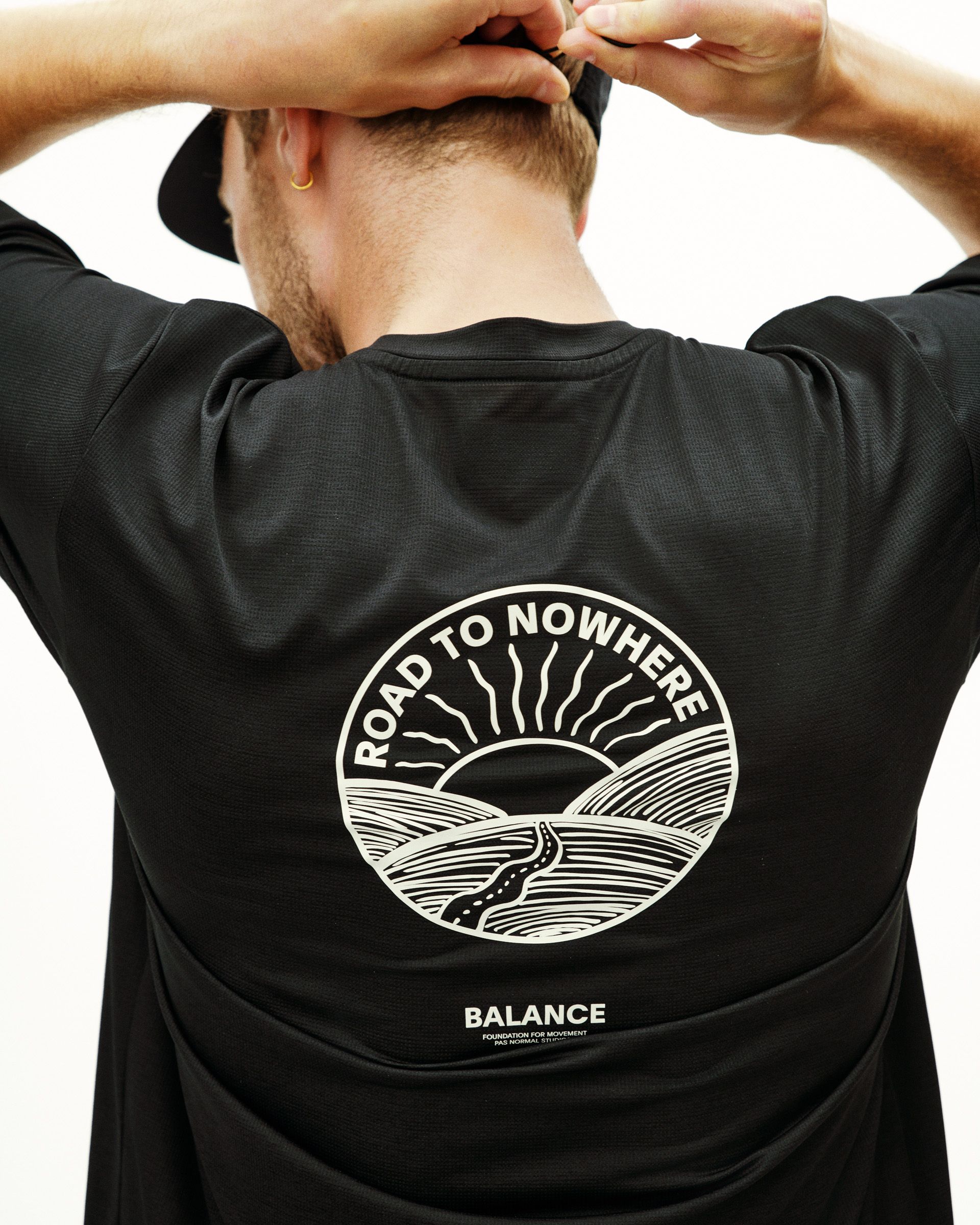 Black Balance t-shirt, rear view on model with white Road to Nowhere circular print