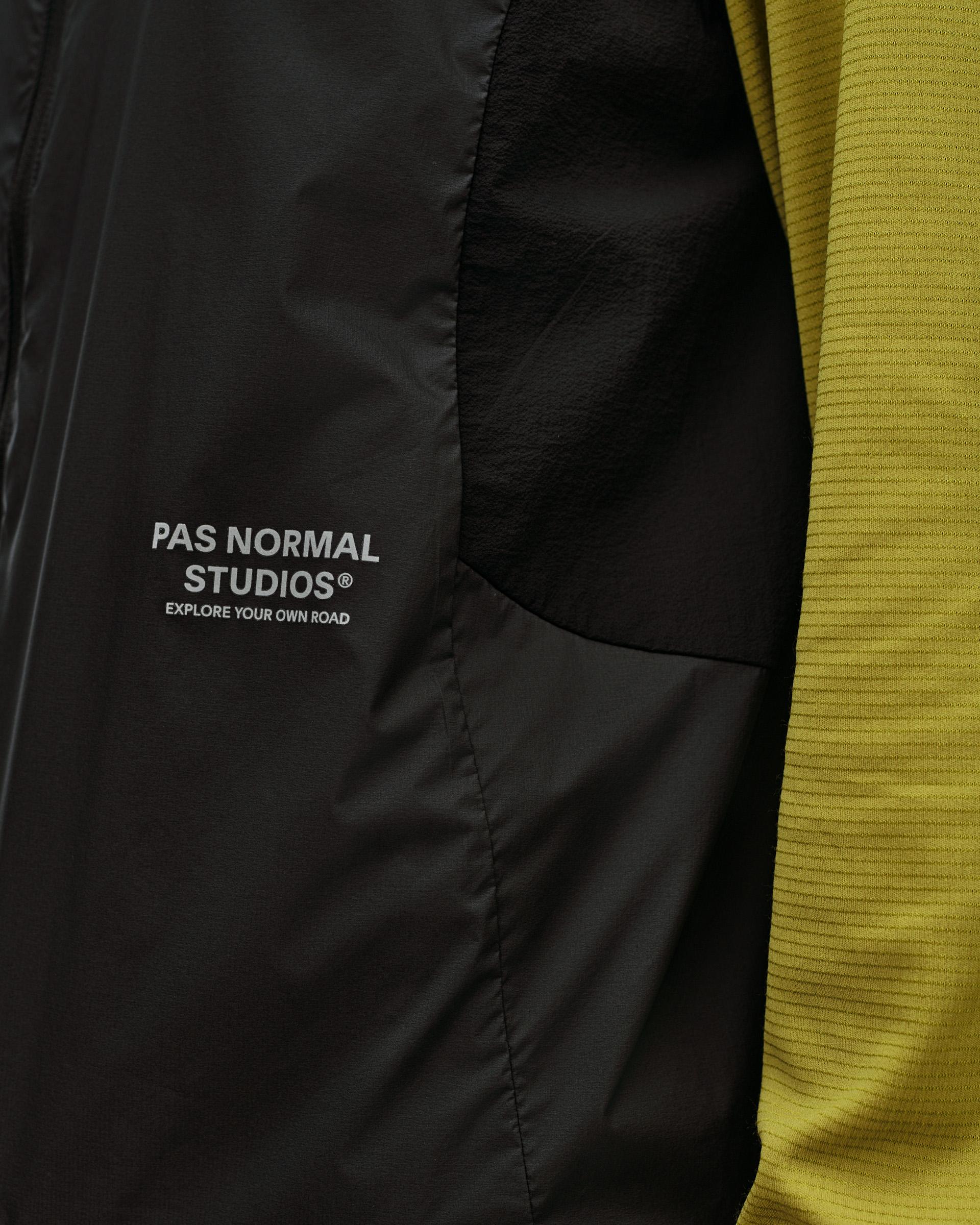Black Balance Windproof Vest, detail view of chest logo print and curved side panel seam