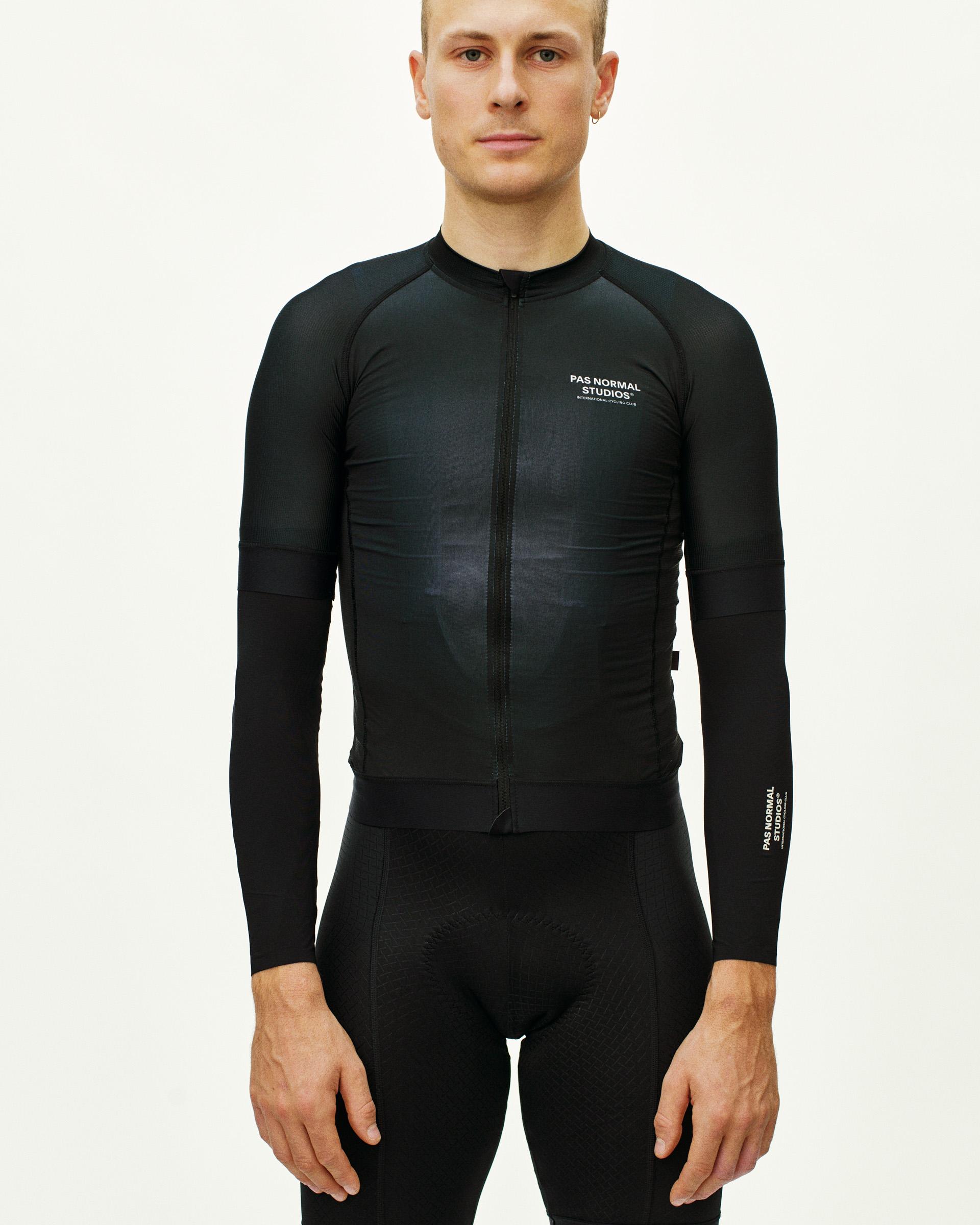 Black Logo UV cycling arm warmers on model with white chest logo