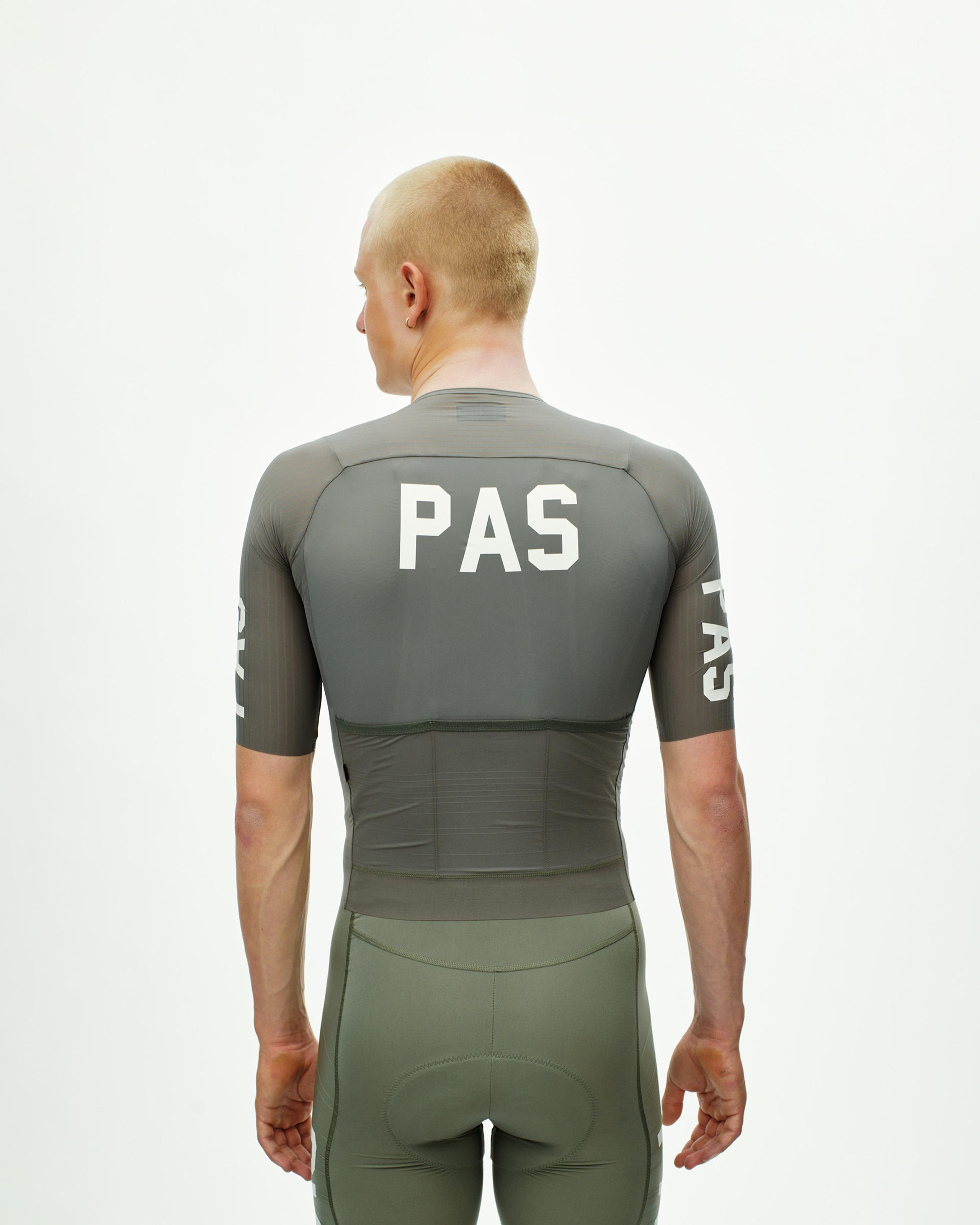 Grey PAS Mechanism Pro cycling jersey on model, rear view with white PAS back and sleeve logos