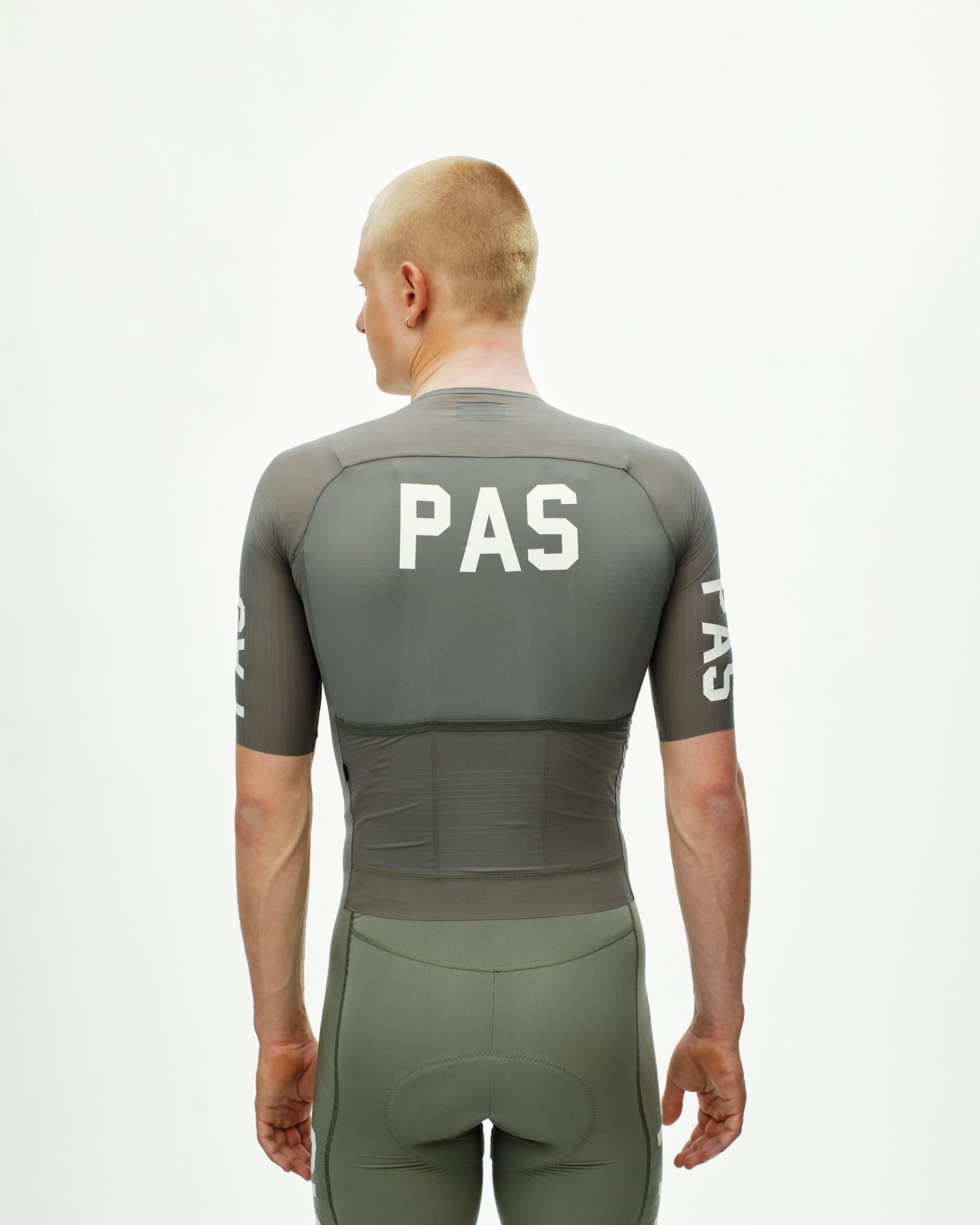 Grey PAS Mechanism Pro cycling jersey on model, rear view with white PAS back and sleeve logos
