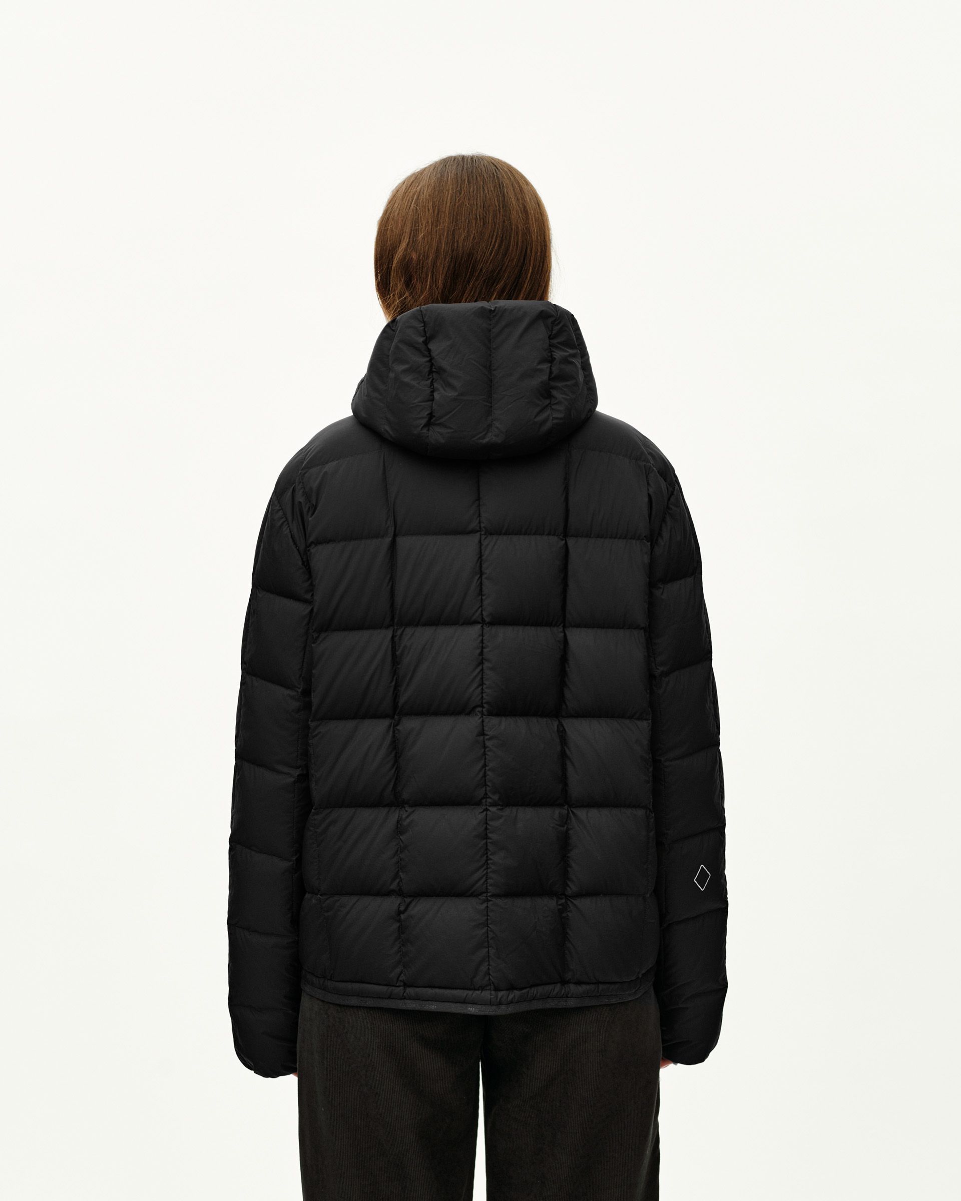 Black Off-Race Down Liner jacket on model, rear view with quilted panels and hood