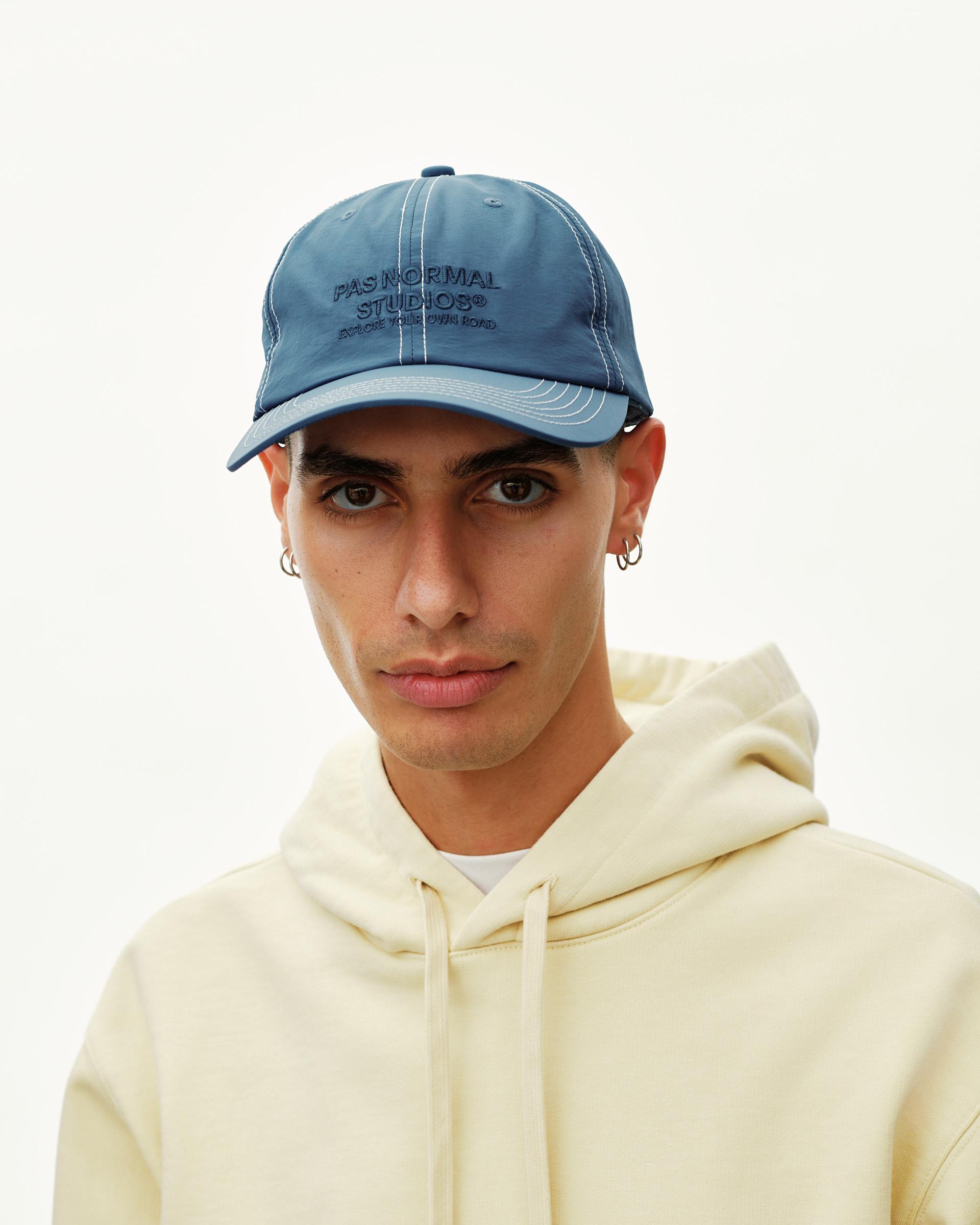 Ocean Blue Off-Race cap on model, front view with contrast stitching and embroidered logo on crown