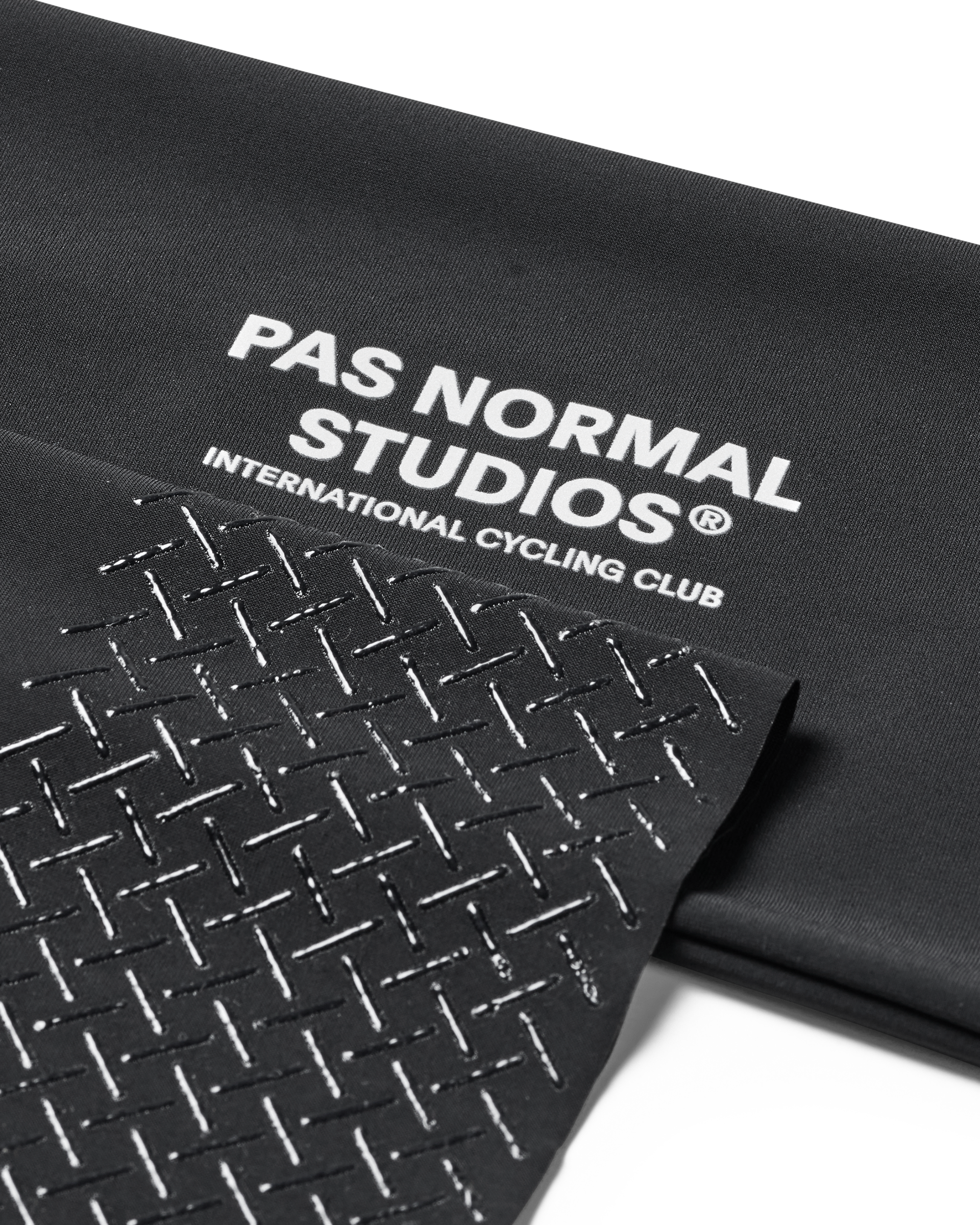 Black Logo Arm UV Protector, detail view showing white text and geometric pattern