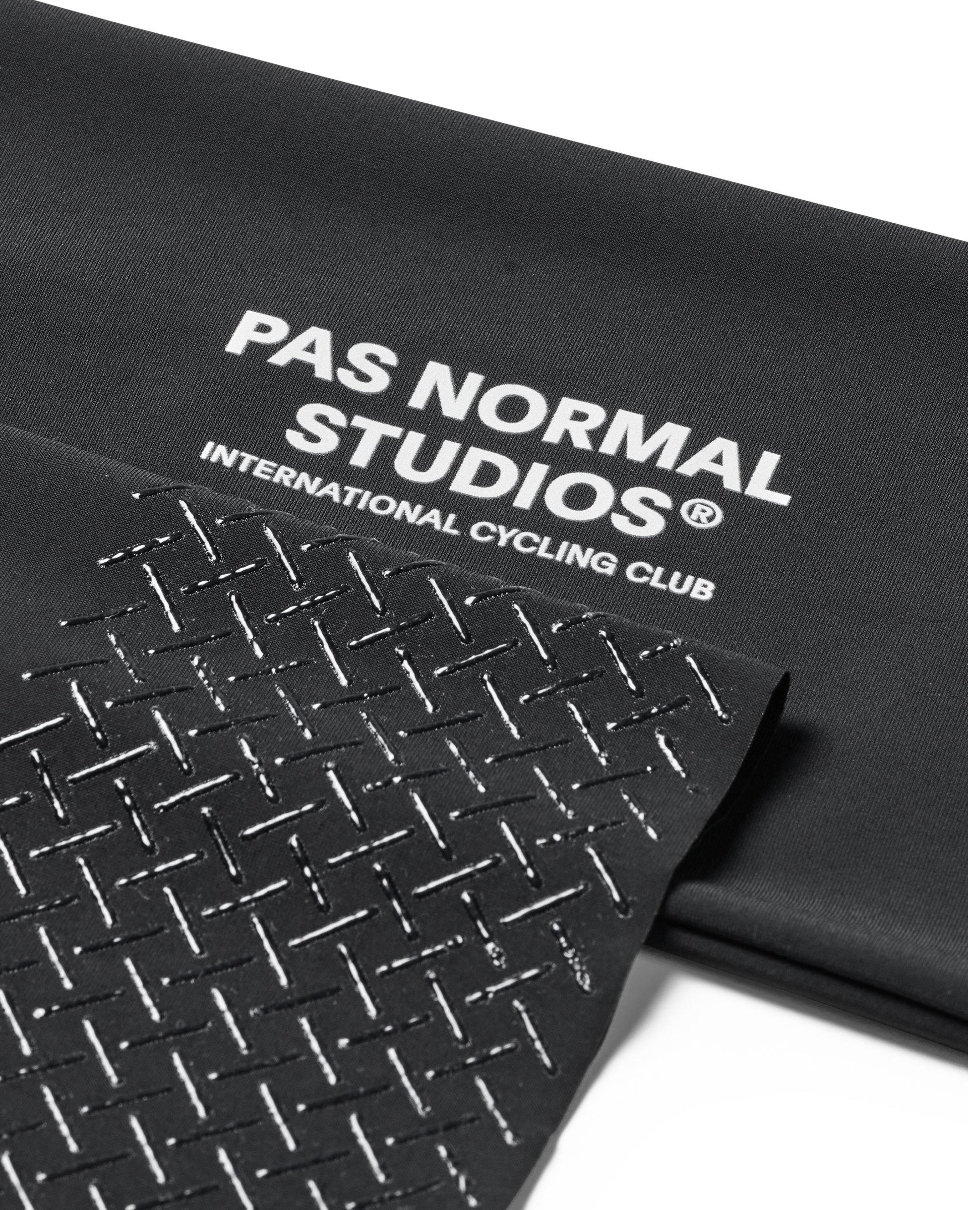 Black Logo Arm UV Protector, detail view showing white text and geometric pattern