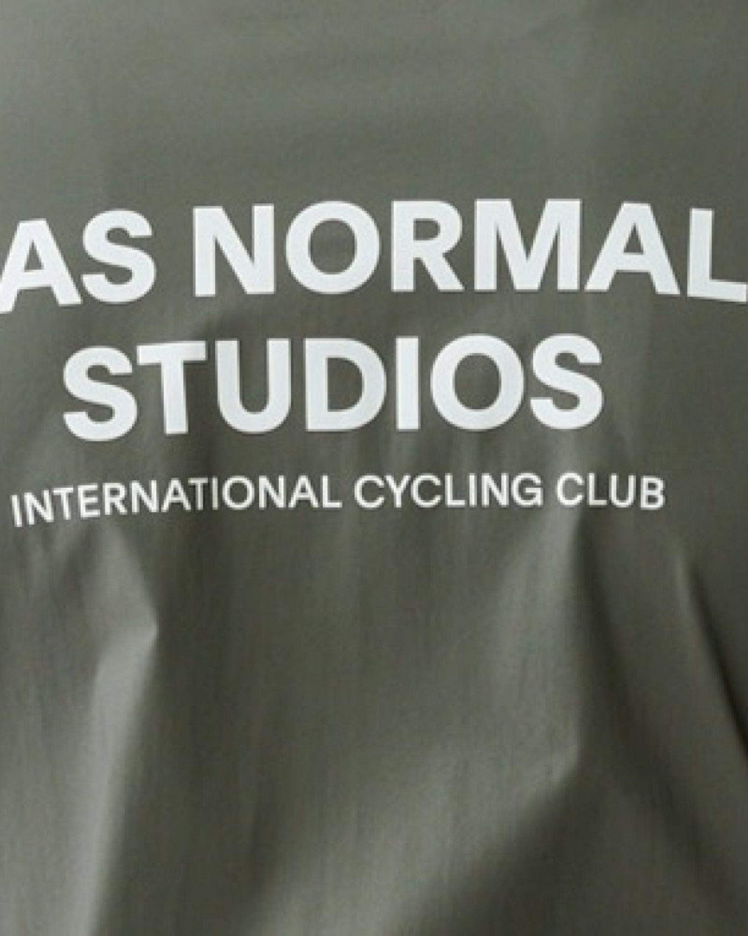 Dark Grey Mechanism Stow Away jacket, front view with white chest logo