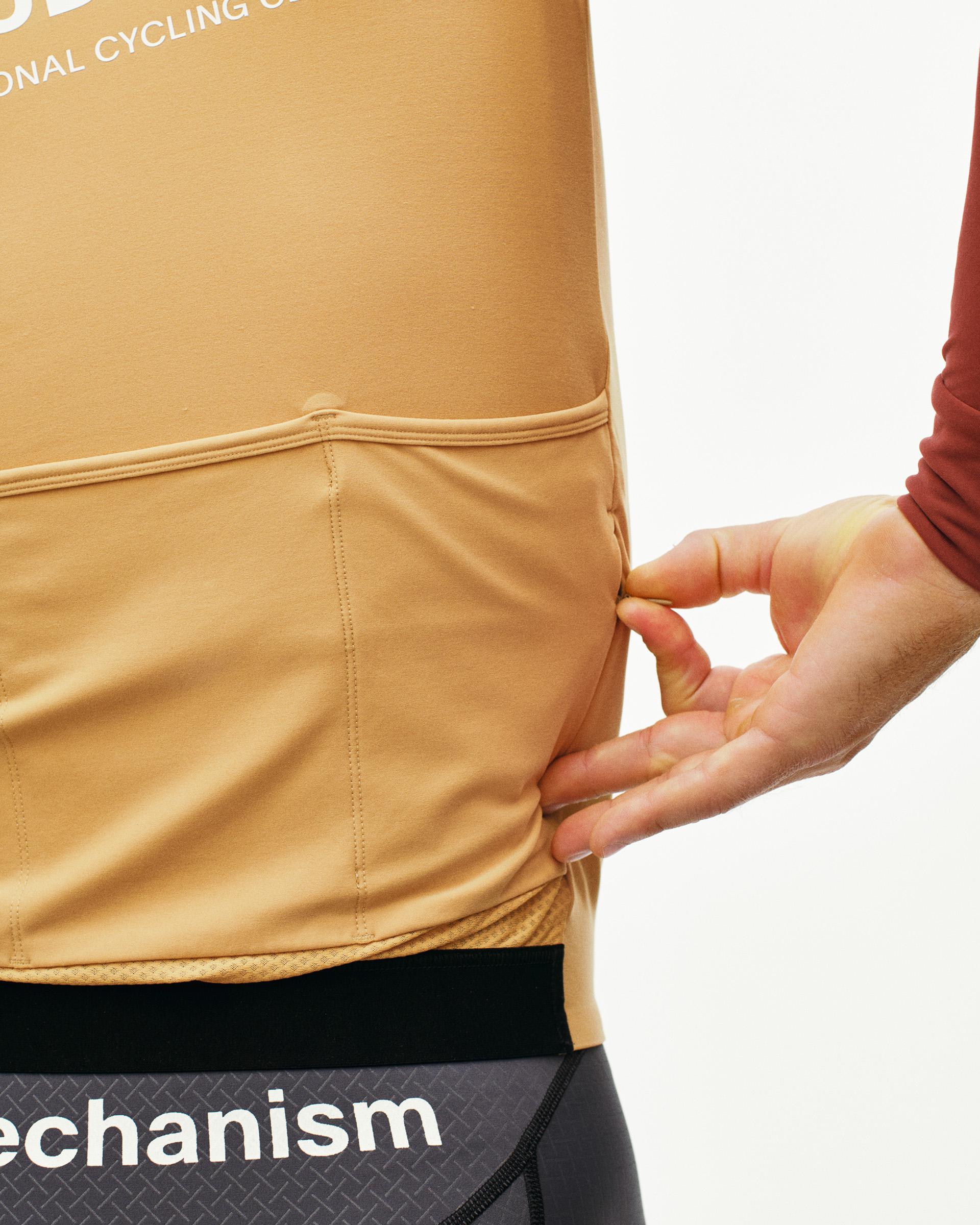 Brown Mechanism long sleeve cycling jersey on model showing contrast stitching and hem detail