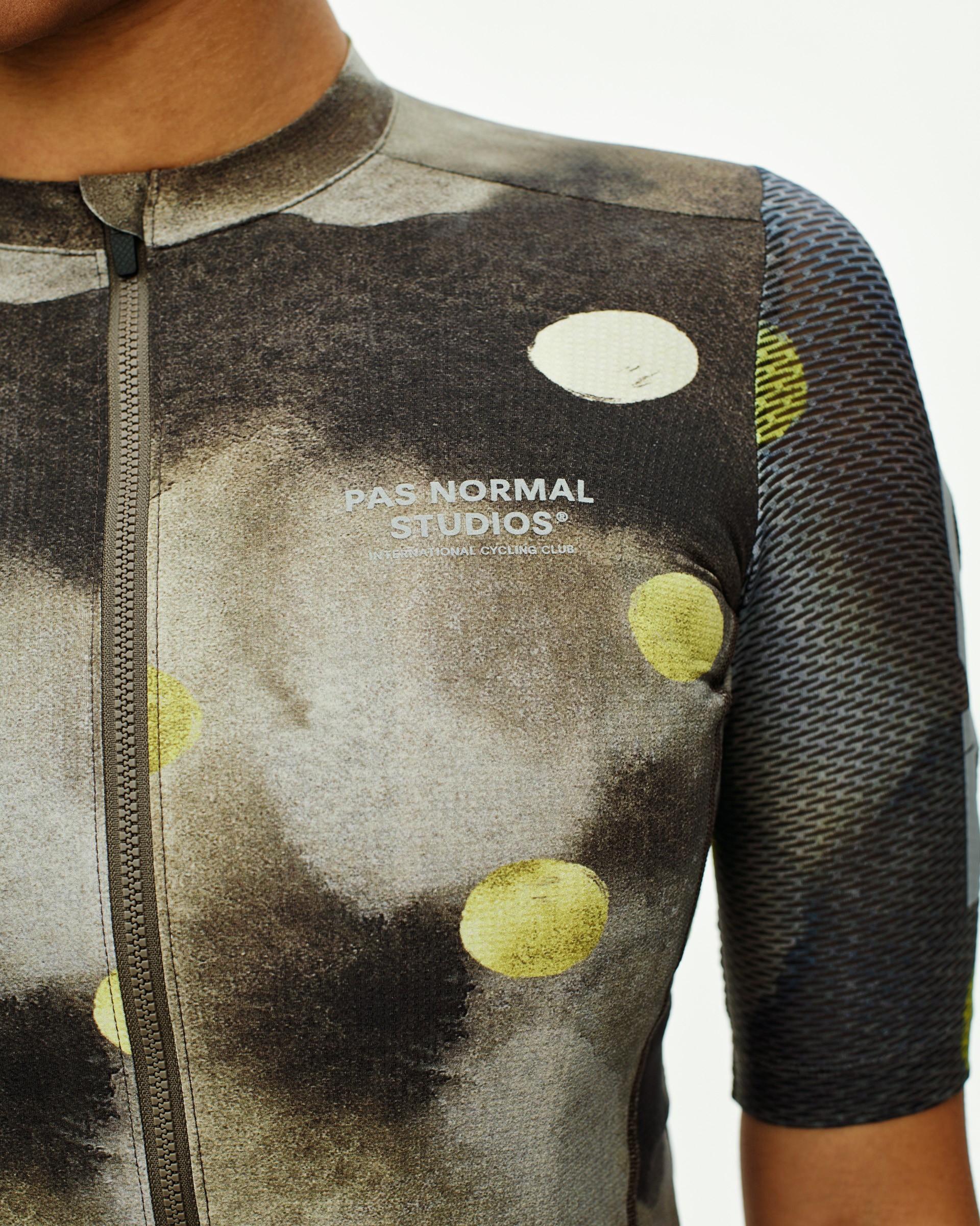 Green T.K.O. Essential Light cycling jersey on model with yellow dot print and contrast mesh sleeves