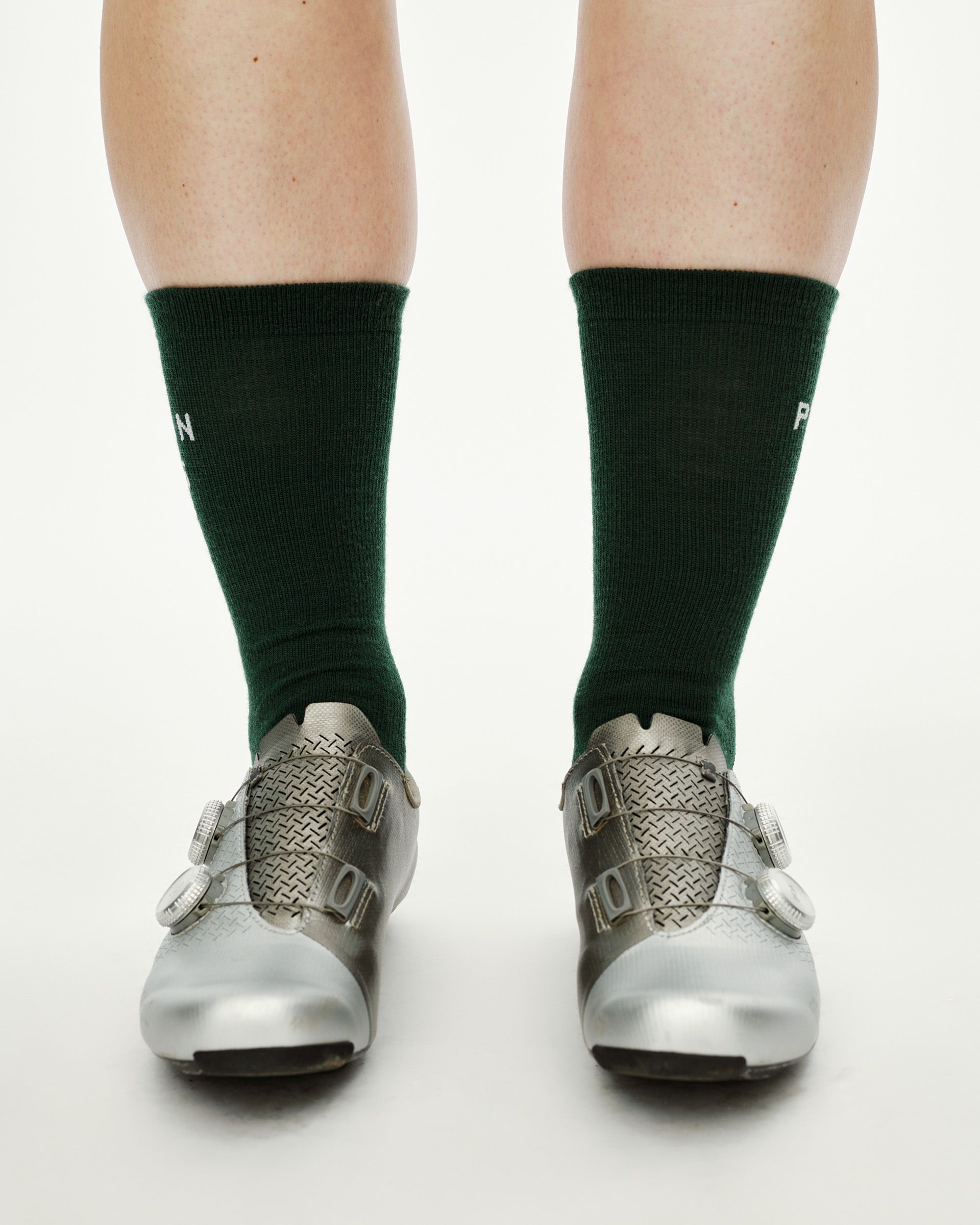 Petroleum green Essential Thermal Wool cycling socks on model, front view with white logo text at calf