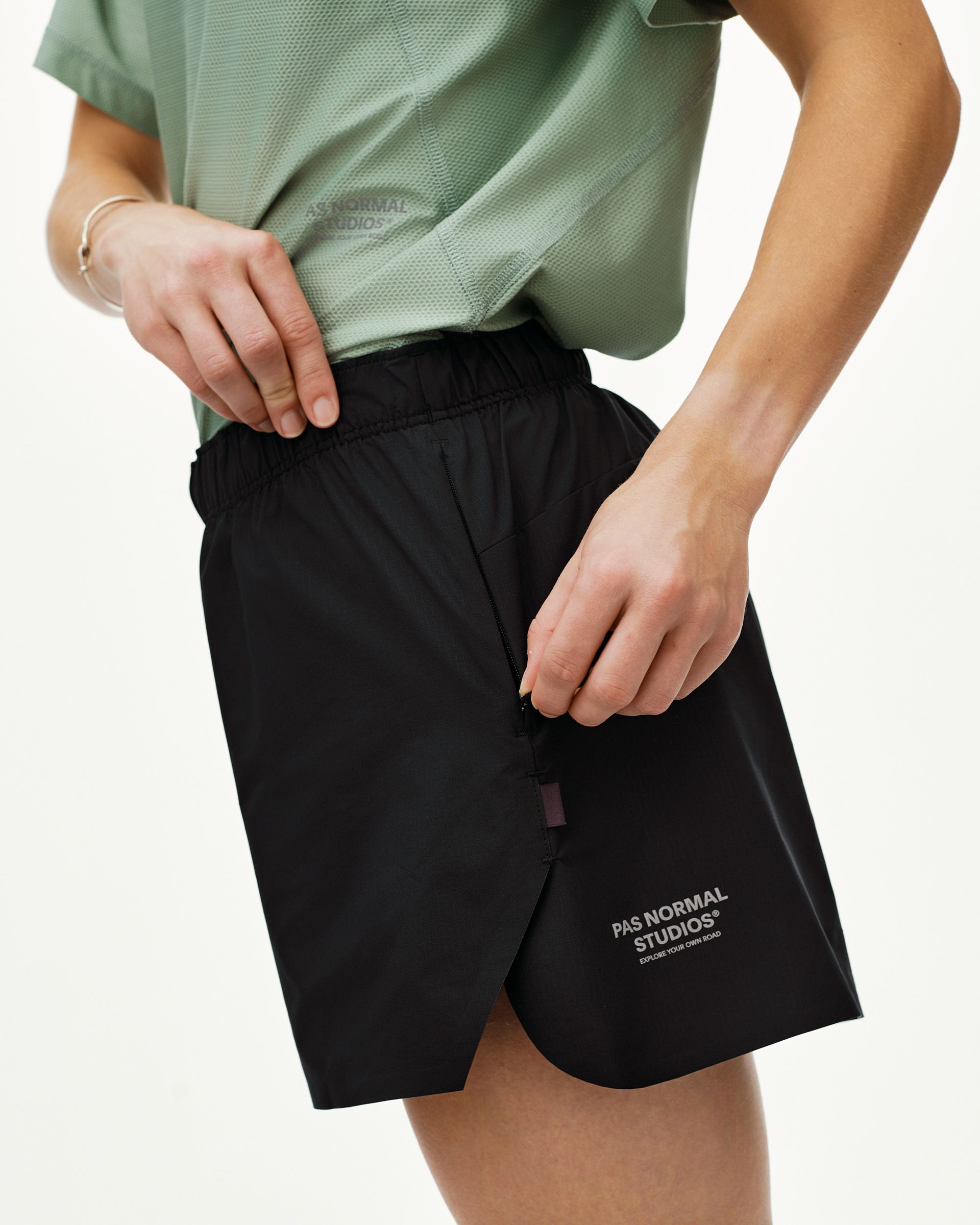 Black Balance women's shorts, side view on model with zip side pocket and elastic waistband