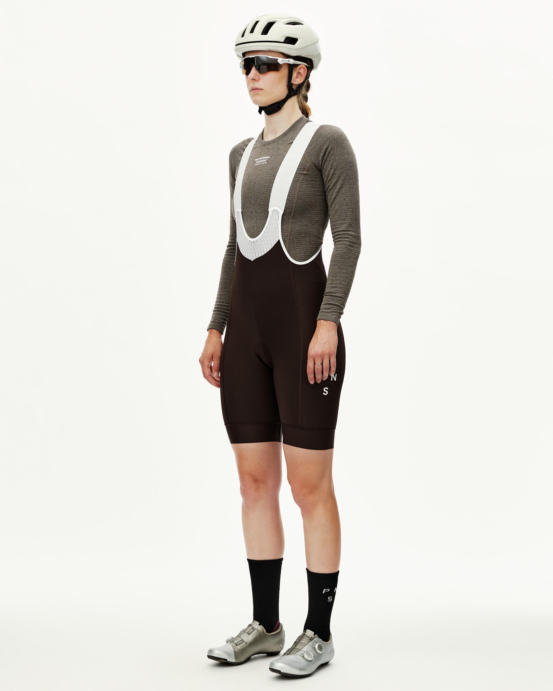 Dark Coffee brown Mechanism Thermal cycling bibs on model, three-quarter front view with white mesh bib straps
