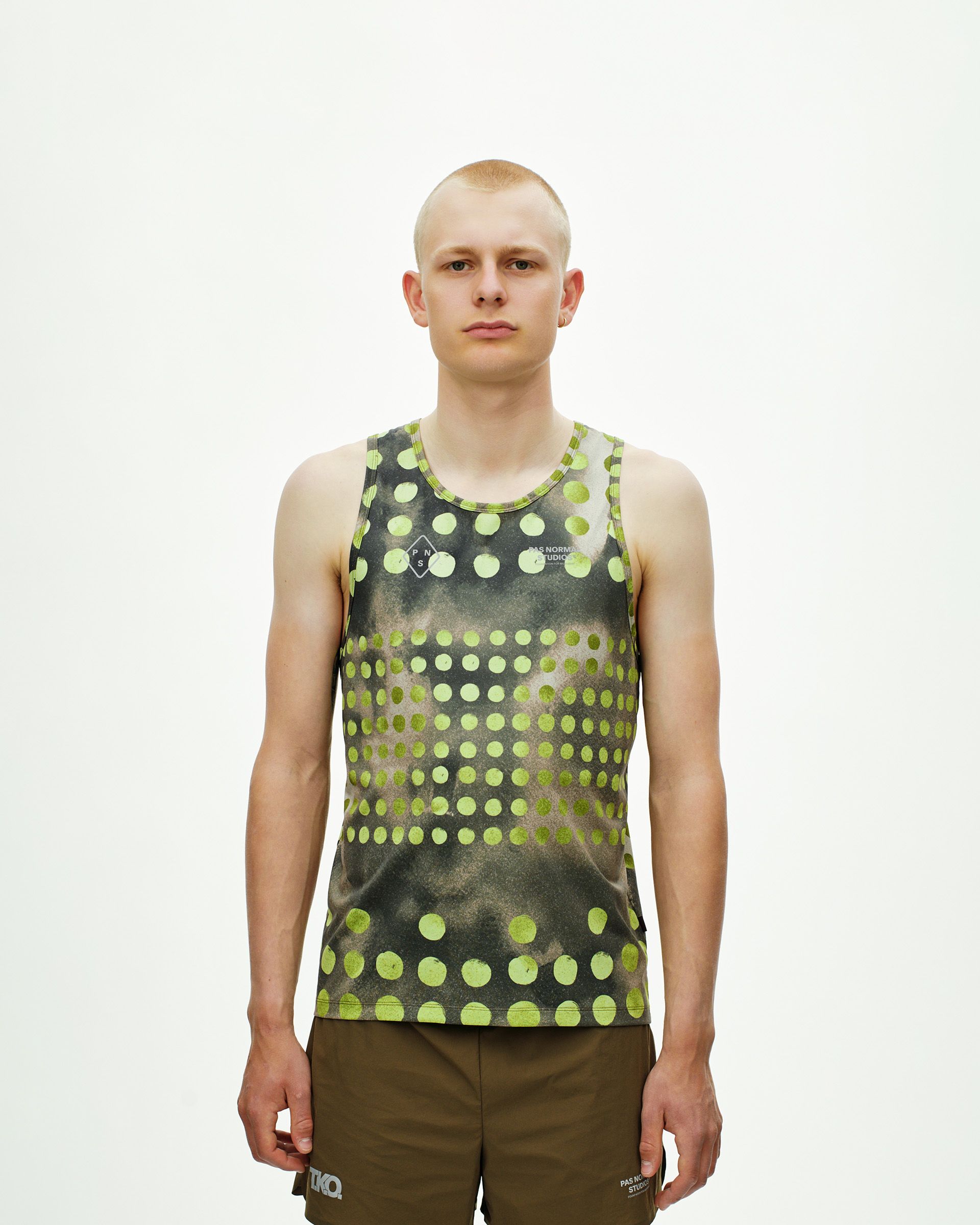 Green T.K.O. Balance singlet on model with yellow polka dot print