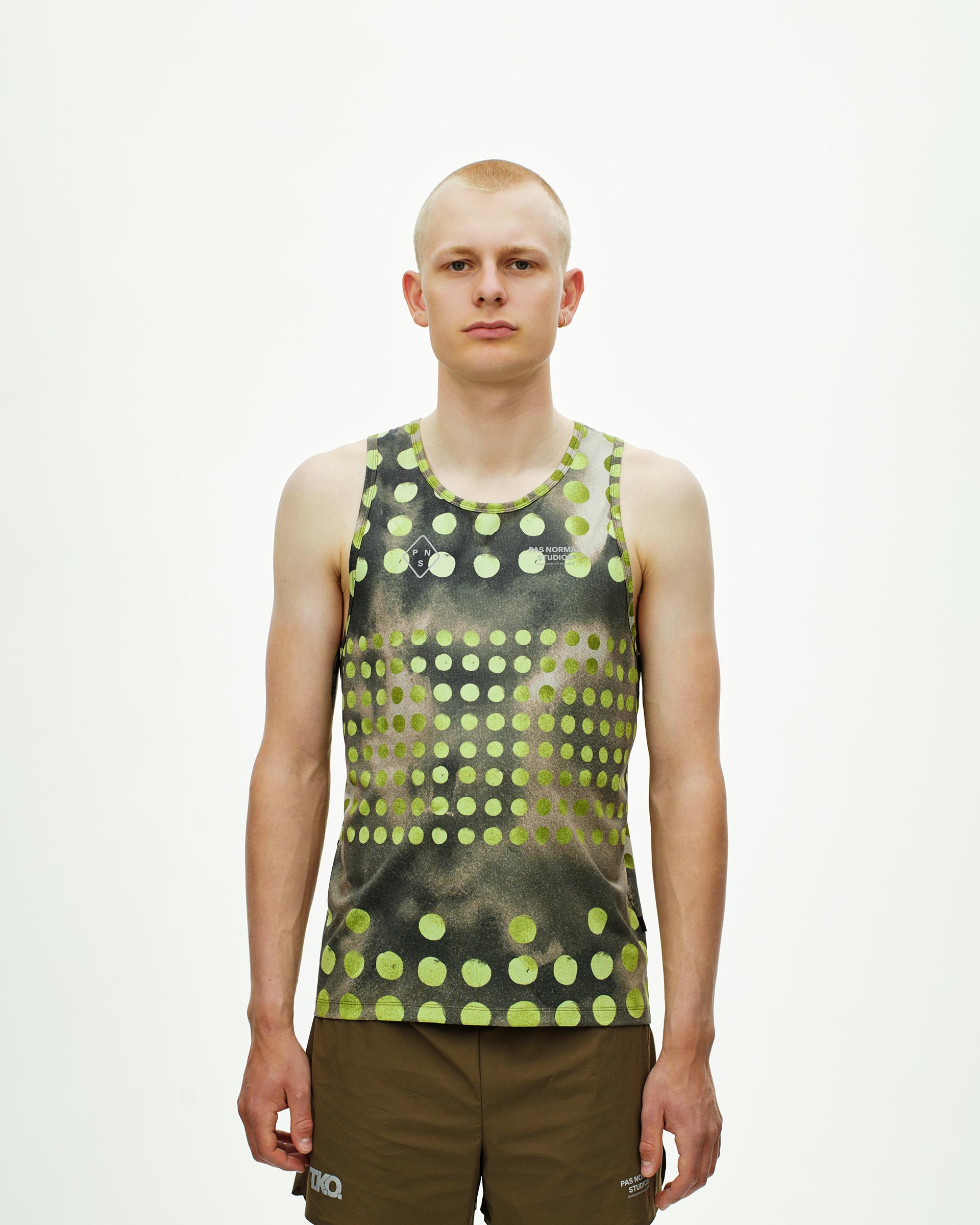 Green T.K.O. Balance singlet on model with yellow polka dot print