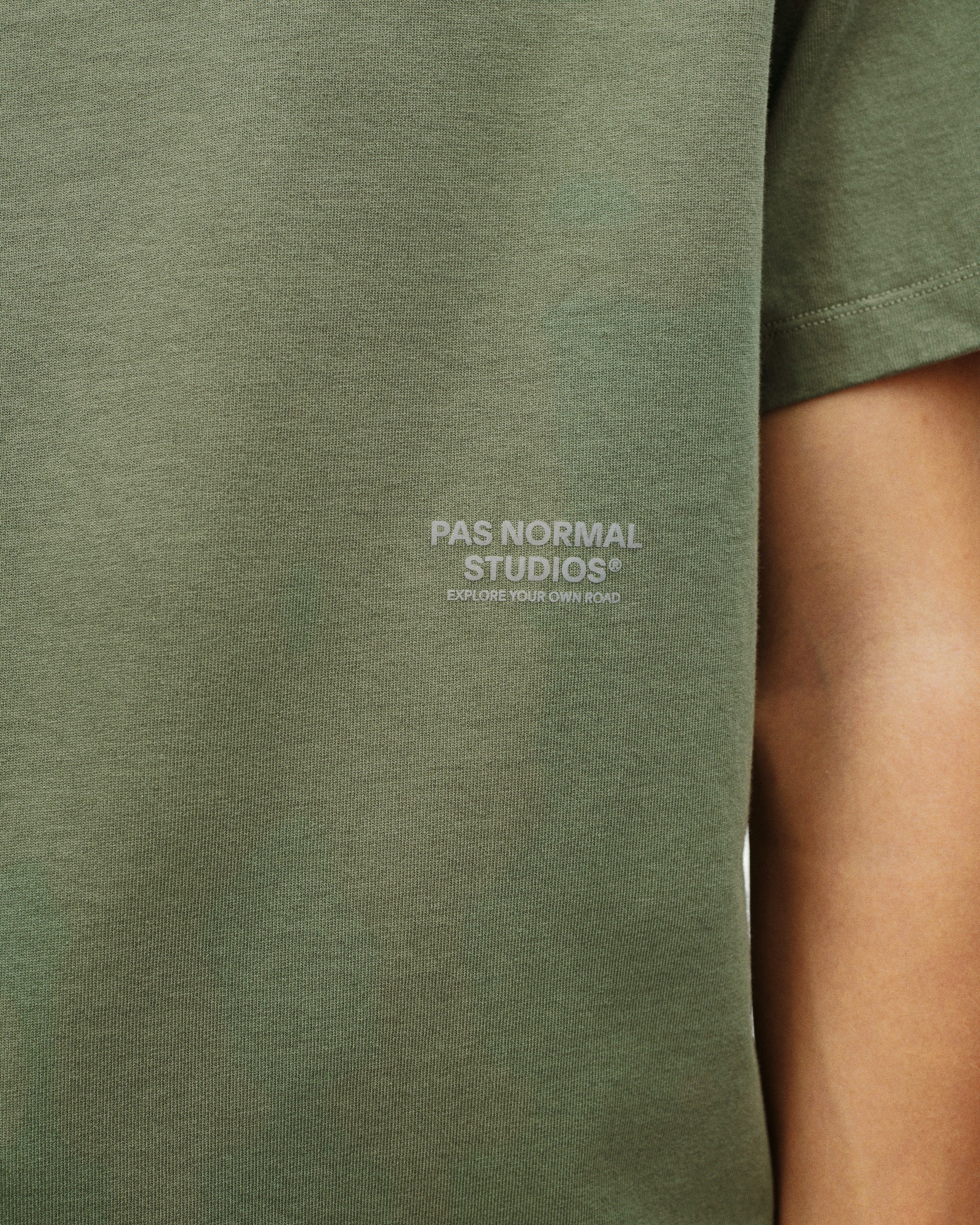 Green Off-Race t-shirt, front detail view with white logo print