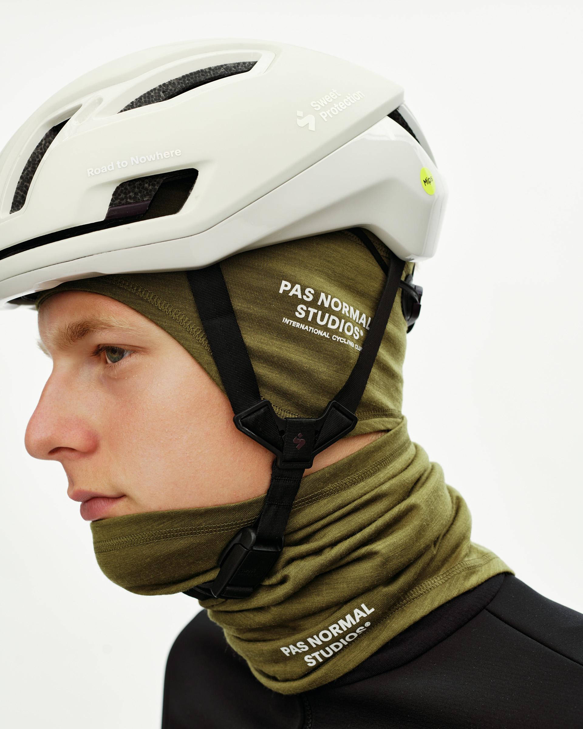 Khaki Green Logo Merino cycling necktube on model, side view with white chest logo print