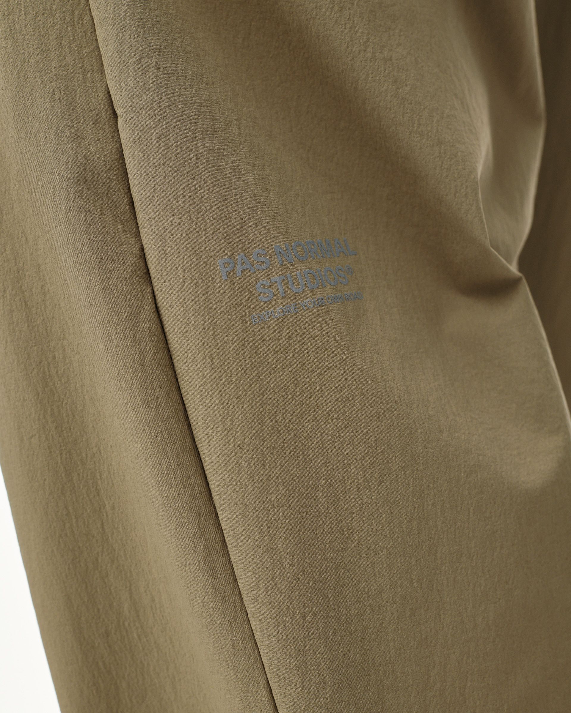 Dusty Earth khaki Off-Race Tech pants, detail view with tonal chest logo print