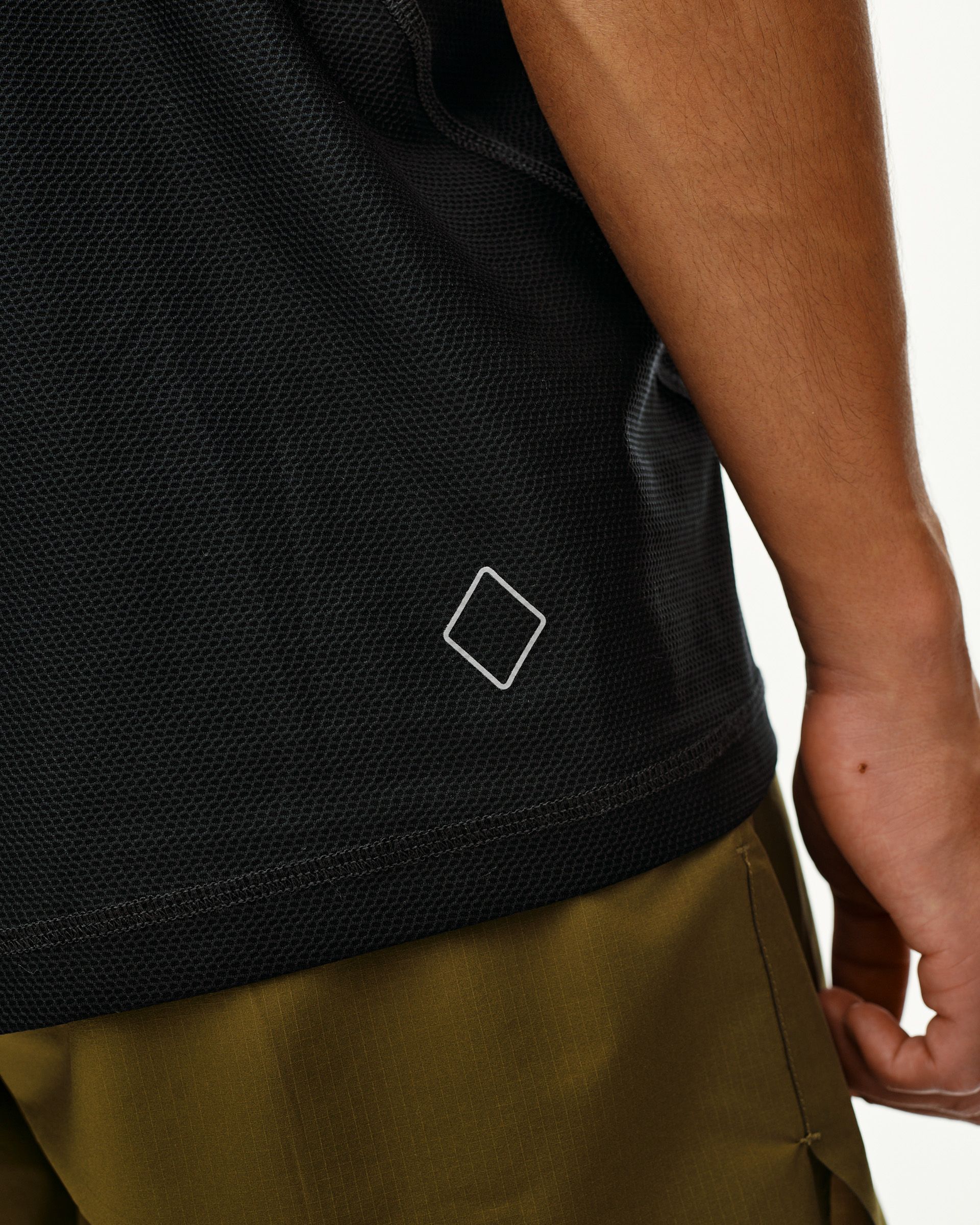 Black Balance T-Shirt, side detail on model with diamond logo badge at hem