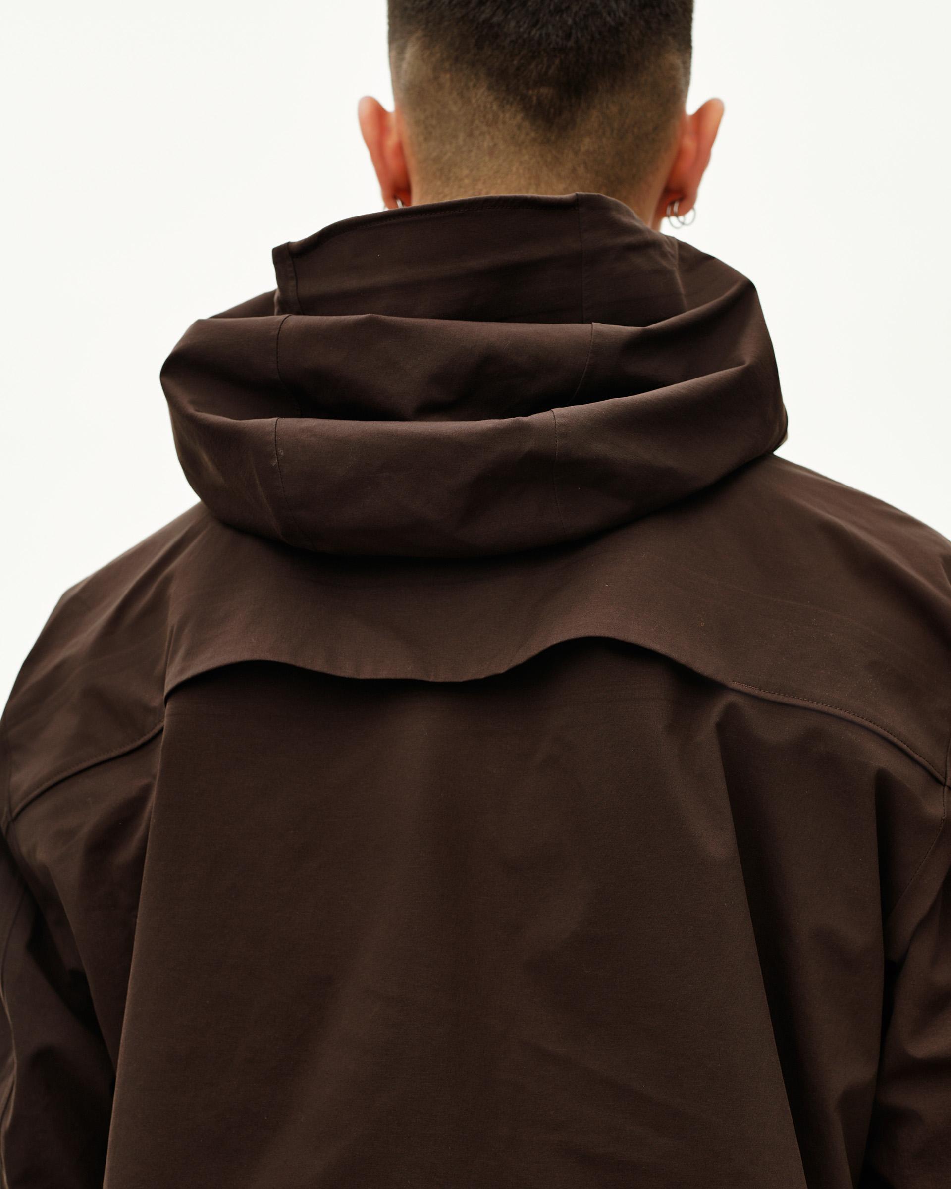 Dark Coffee brown Off-Race 3L Shell jacket on model, rear view with structured storm hood