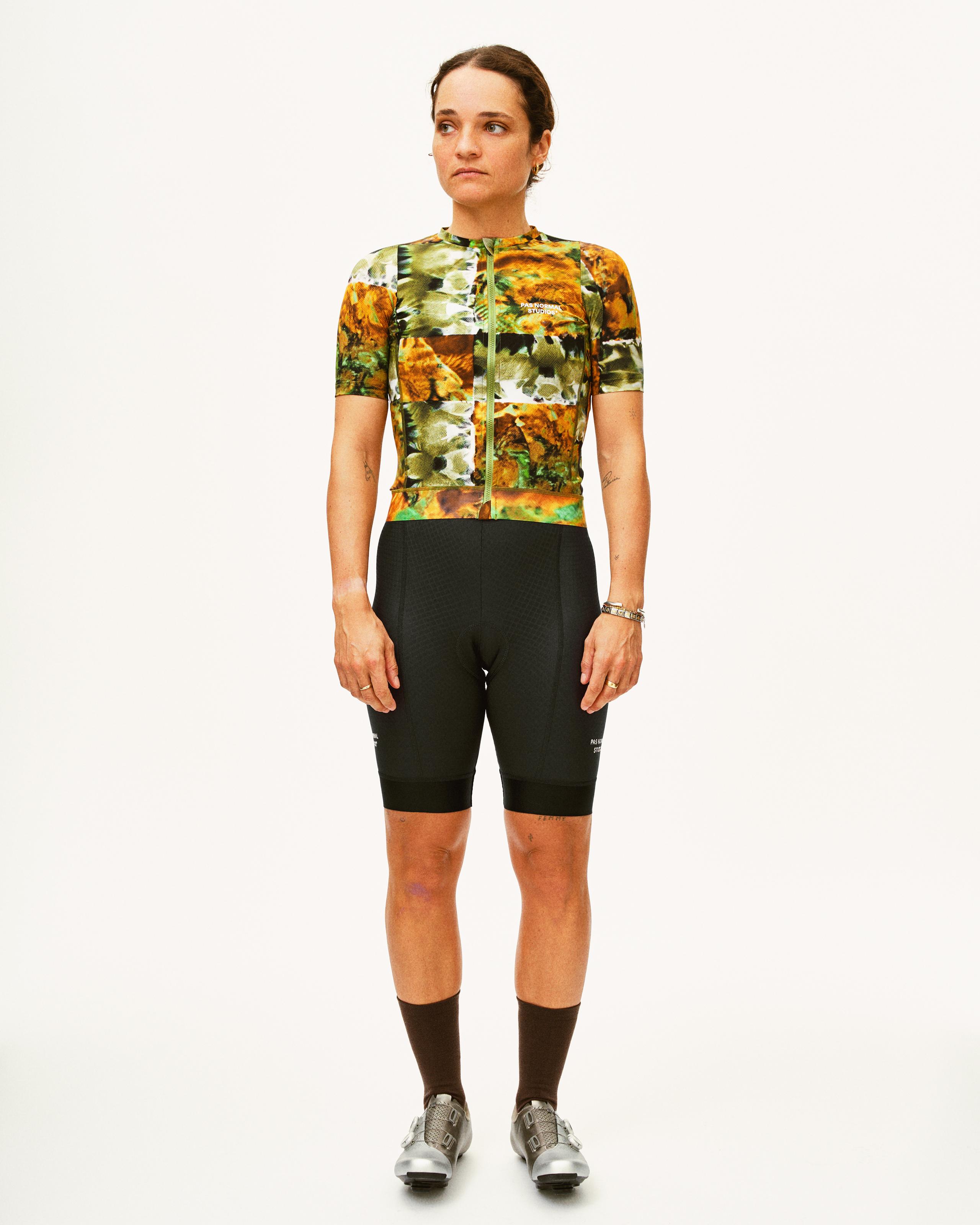 Black Essential cycling bibs on model with floral print jersey